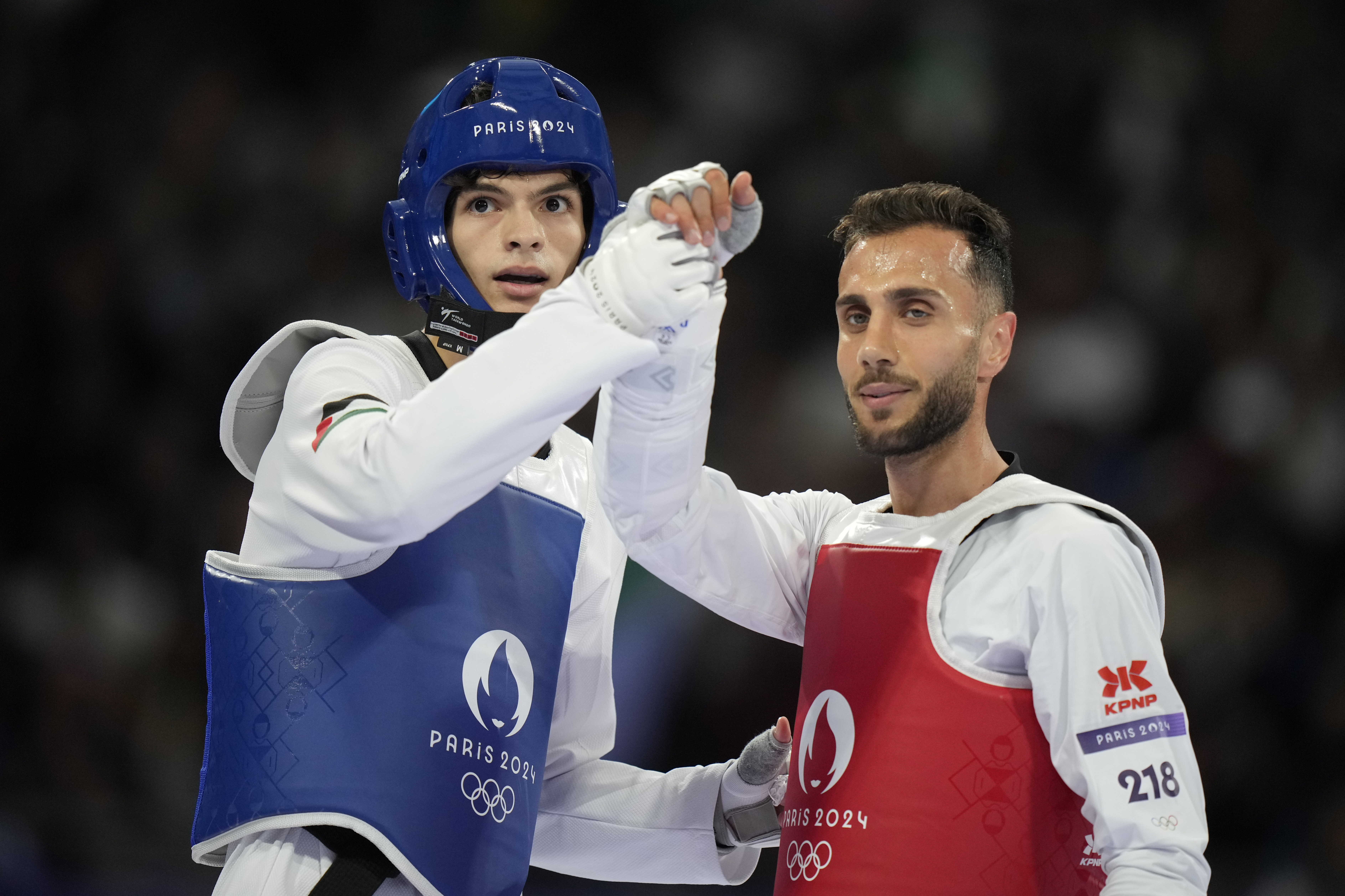 Palestine's Omar Yaser Ismail, left, competes with Refugees Olympic Team's Hadi Tiranvalipour in a men's 58kg Taekwondo match during the 2024 Summer Olympics, at the Grand Palais, Wednesday, Aug. 7, 2024, in Paris, France. 