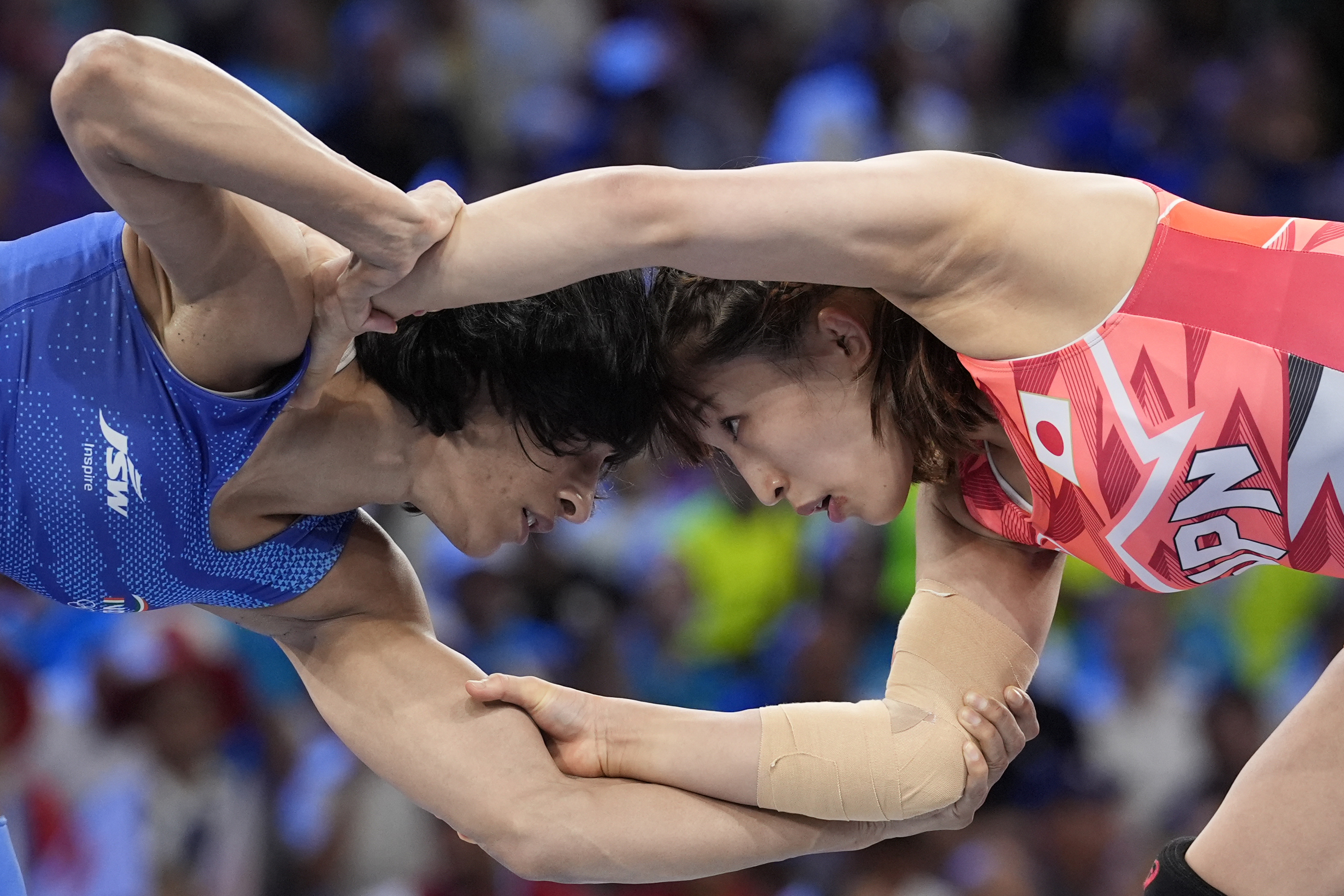 Japan's Yui Susaki and India's Vinesh Vinesh, left, compete in the round of 16 of the women's freestyle 50kg wrestling match, at Champ-de-Mars Arena, during the 2024 Summer Olympics, Tuesday, Aug. 6, 2024, in Paris, France. 