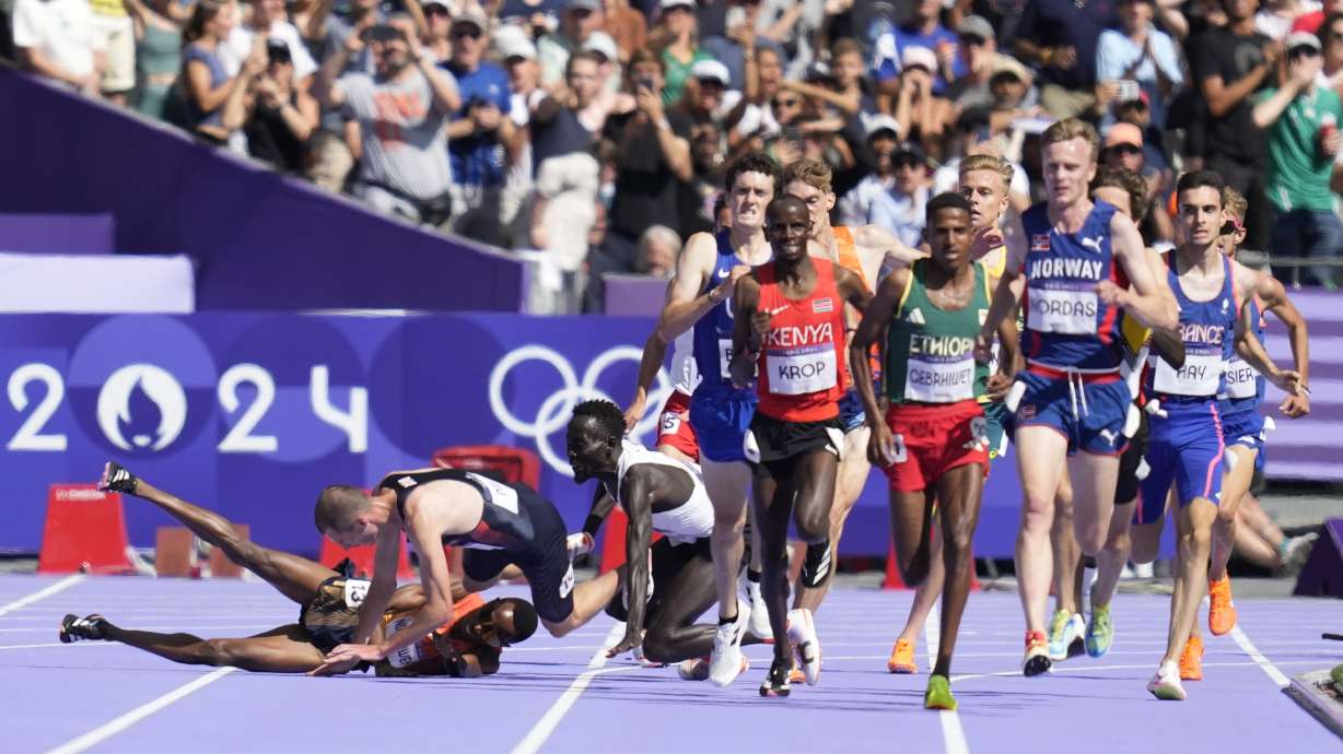 Runners fall in their heat of the men's 5000-meters at the 2024 Summer Olympics, Wednesday, Aug. 7, 2024, in Saint-Denis, France.