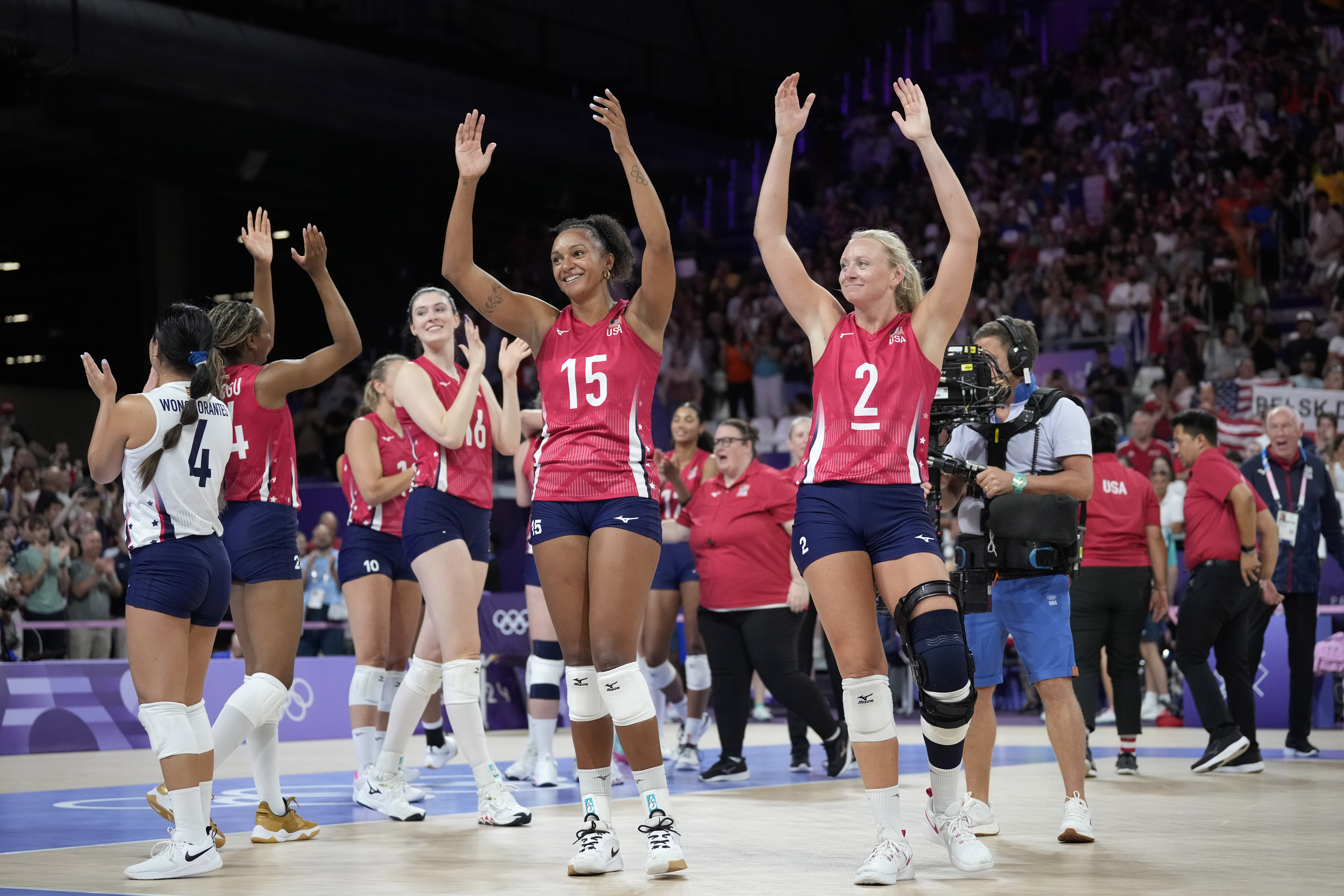 Haleigh Washington, center, and Jordyn Poulter, right, of the United States, celebrate at the end of a women's quarter final volleyball match between the United States and Poland at the 2024 Summer Olympics, Tuesday, Aug. 6, 2024, in Paris, France. 