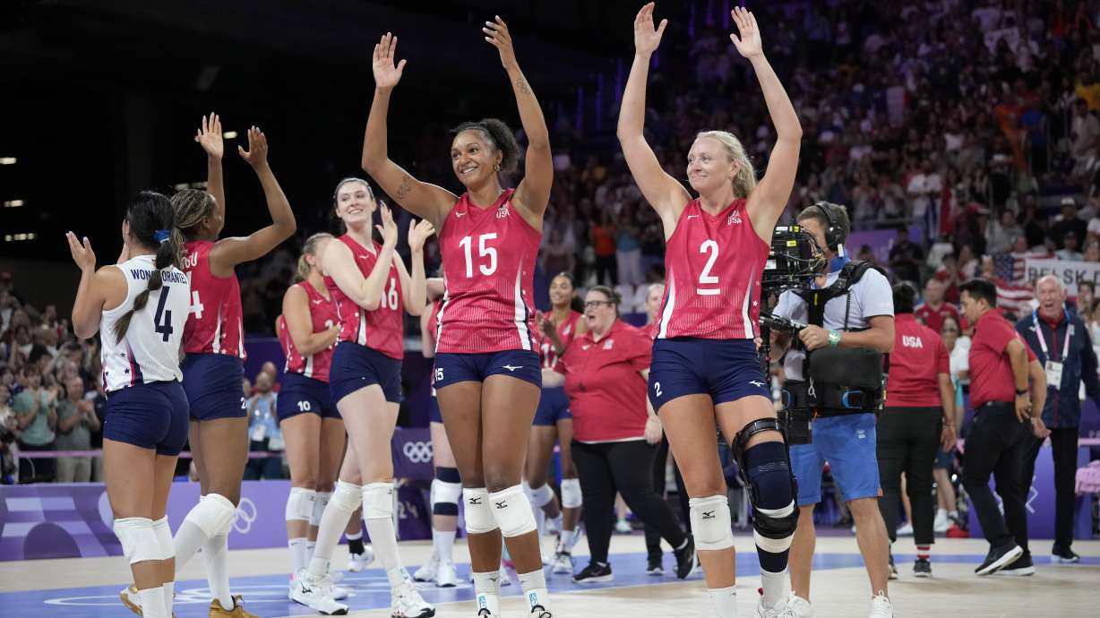 Haleigh Washington, center, and Jordyn Poulter, right, of the United States, celebrate at the end of a women's quarter final volleyball match between the United States and Poland at the 2024 Summer Olympics, Tuesday, Aug. 6, 2024, in Paris, France.