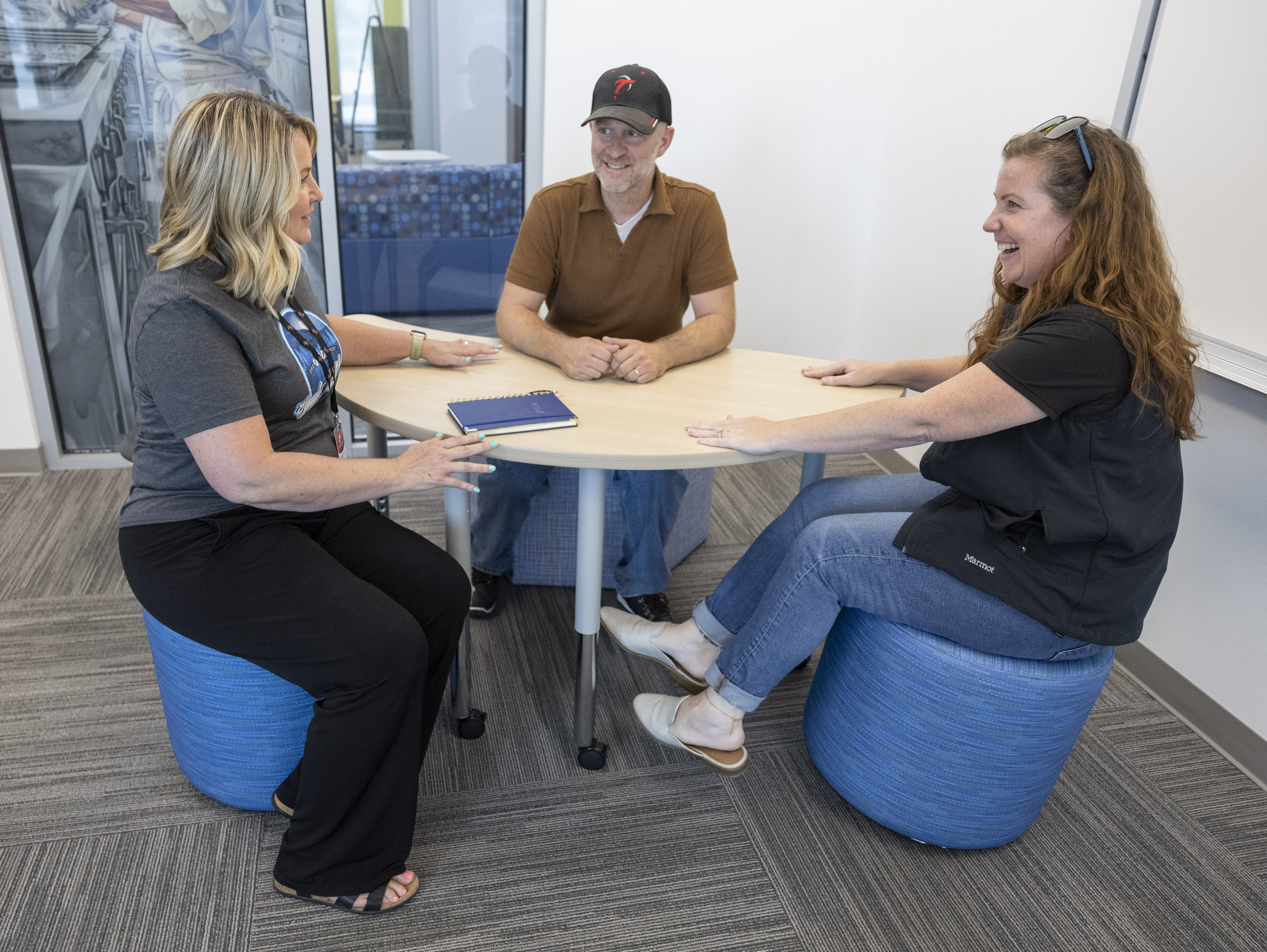 From right to left, KC Strong, Joshua Reeves and Teresa Taylor, all counselors at Ogden-Weber Technical College, test out the new chairs and table in a classroom during a public open house event to celebrate the opening of Ogden Technical High School in Ogden on Tuesday.