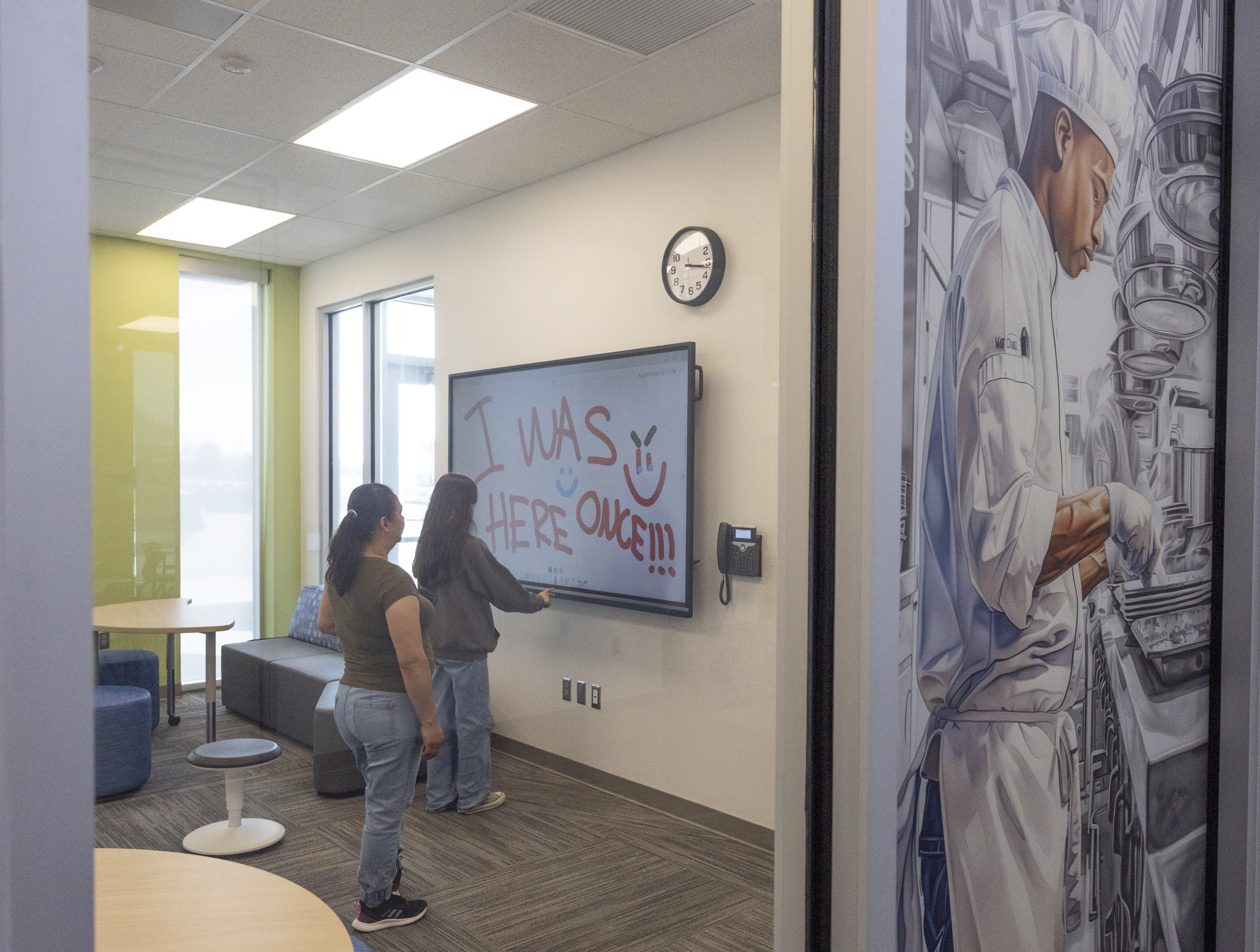 Yahaira Carrillo uses a smart board with her mother, Rosa Carrillo, during a public open house event to celebrate the opening of Ogden Technical High School in Ogden on Tuesday, Aug. 6, 2024.