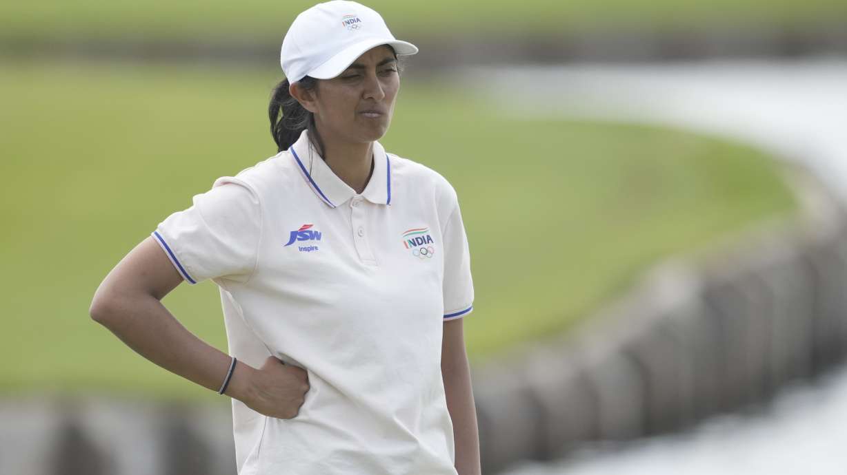 Aditi Ashok, of India, reacts after a double bogey on the 18th green during the first round of the women's golf event at the 2024 Summer Olympics, Wednesday, Aug. 7, 2024, at Le Golf National, in Saint-Quentin-en-Yvelines, France.