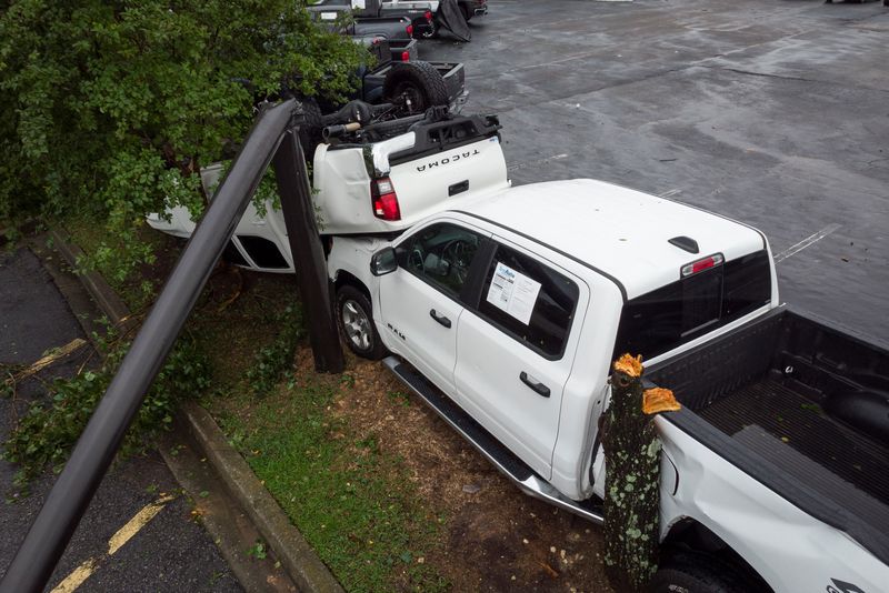 Damaged trucks are seen at a car dealer after a tornado hit the area as Tropical Storm Debby drifts in the East Coast, in Moncks Corner, S.C., Wednesday.