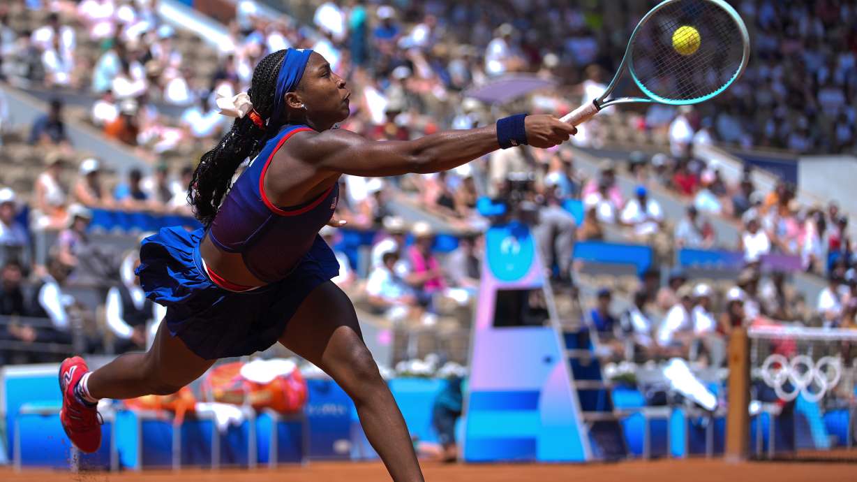 Coco Gauff of United States returns a shot to Donna Vekic of Croatia during their women's singles third round match at the Roland Garros stadium, at the 2024 Summer Olympics, Tuesday, July 30, 2024, in Paris, France.