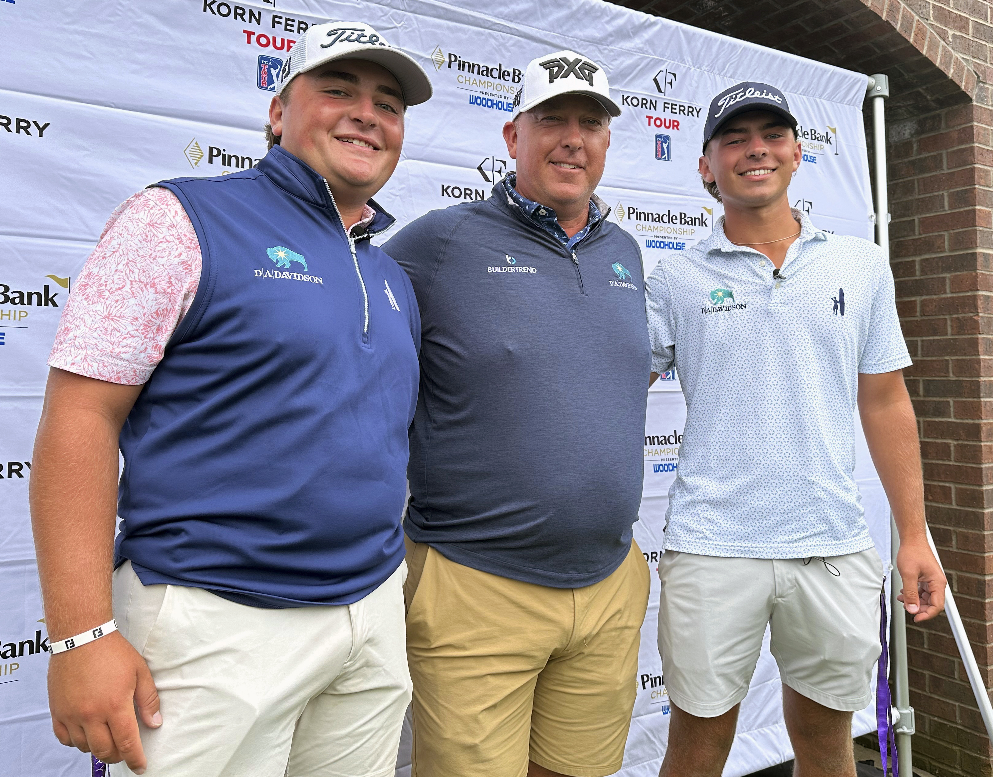 Scott Gutschewski is flanked by his sons, Luke, left, and Trevor ahead of the Korn Ferry Tour’s Pinnacle Bank Championship golf tournament, Tuesday, Aug. 6, 2024, in Omaha, Neb.