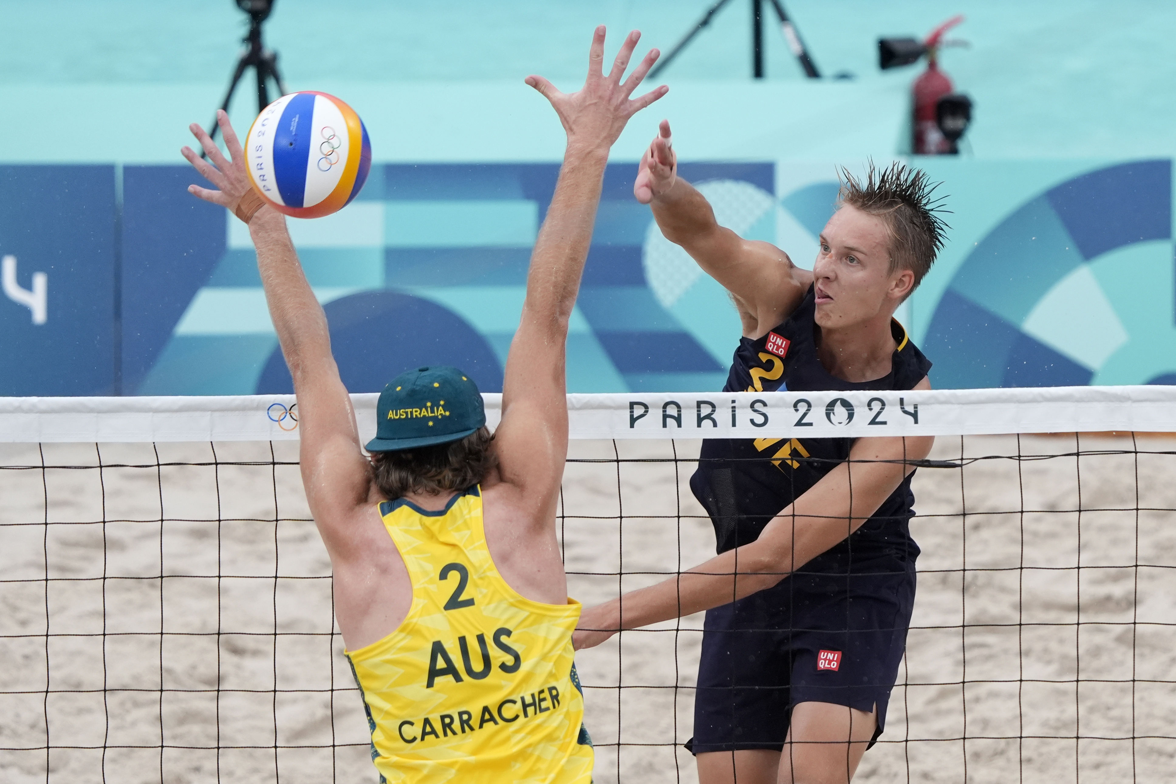Sweden's Jonatan Hellvig scores against Australia's Izac Carracher during a beach volleyball match at the 2024 Summer Olympics, Saturday, July 27, 2024, in Paris, France. 
