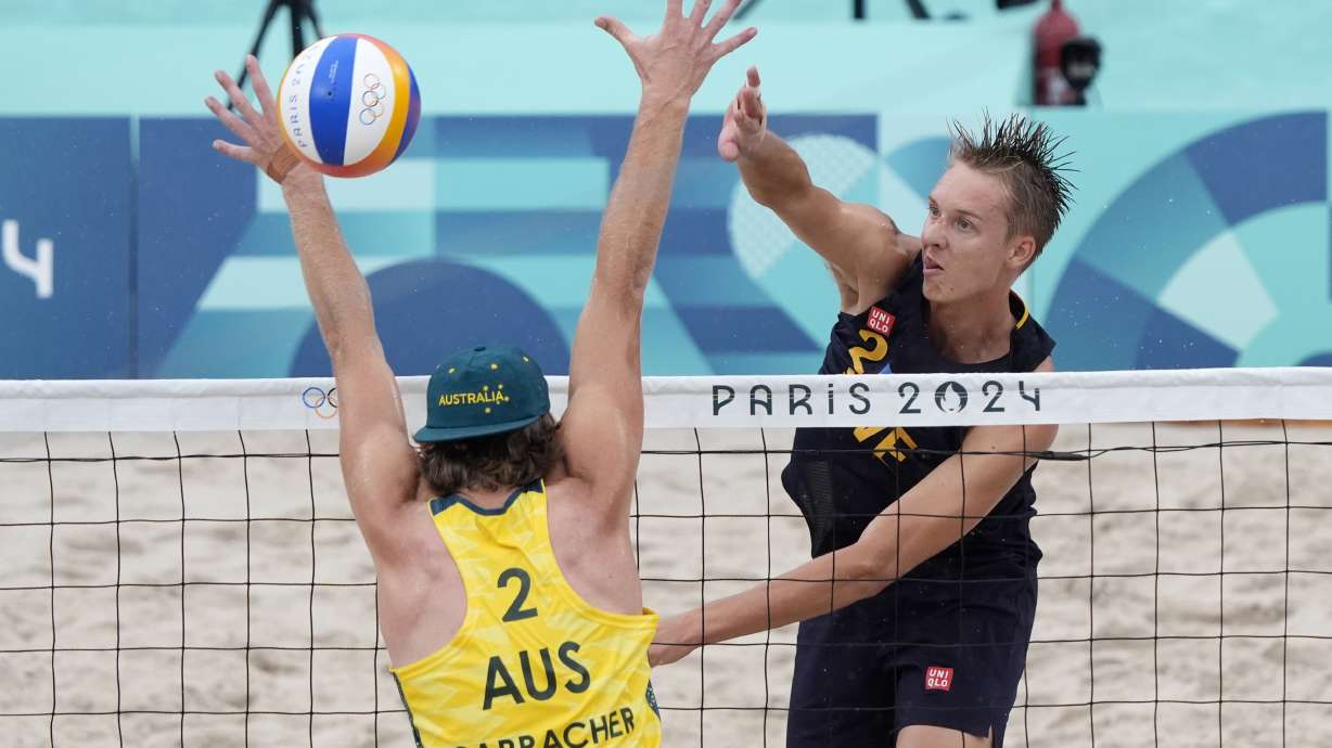 Sweden's Jonatan Hellvig scores against Australia's Izac Carracher during a beach volleyball match at the 2024 Summer Olympics, Saturday, July 27, 2024, in Paris, France.