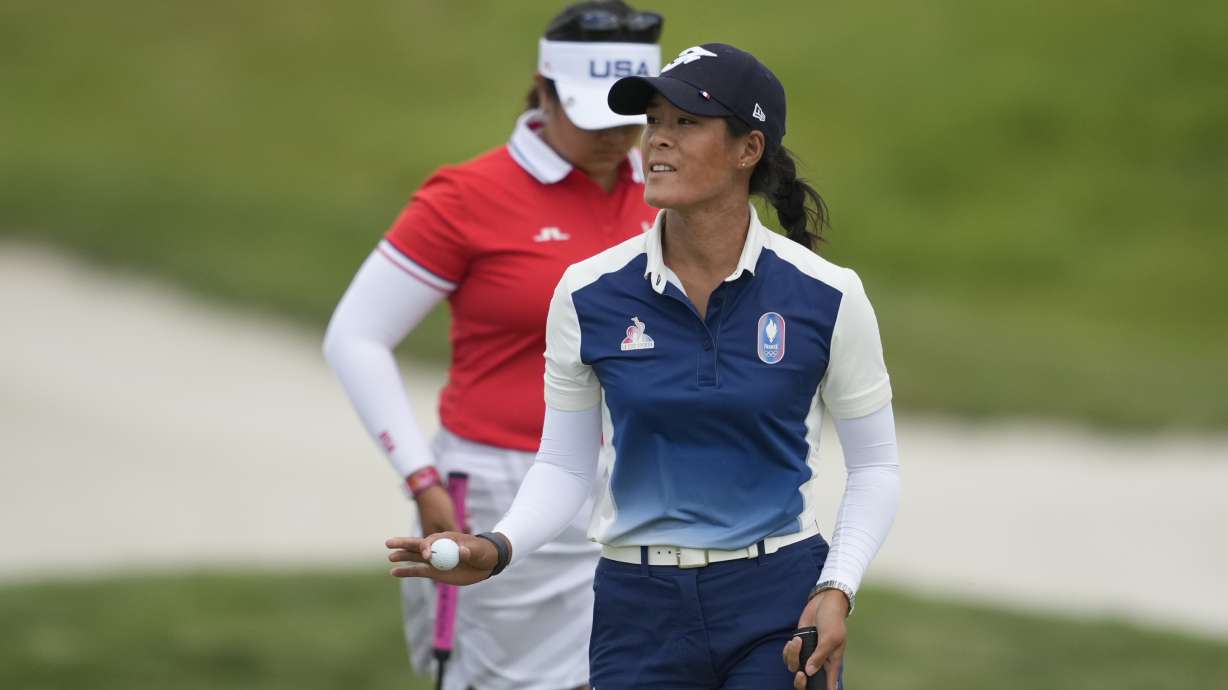 Celine Boutier, of France, acknowledges the crowd after putting on the 14th green during the first round of the women's golf event at the 2024 Summer Olympics, Wednesday, Aug. 7, 2024, at Le Golf National, in Saint-Quentin-en-Yvelines, France.
