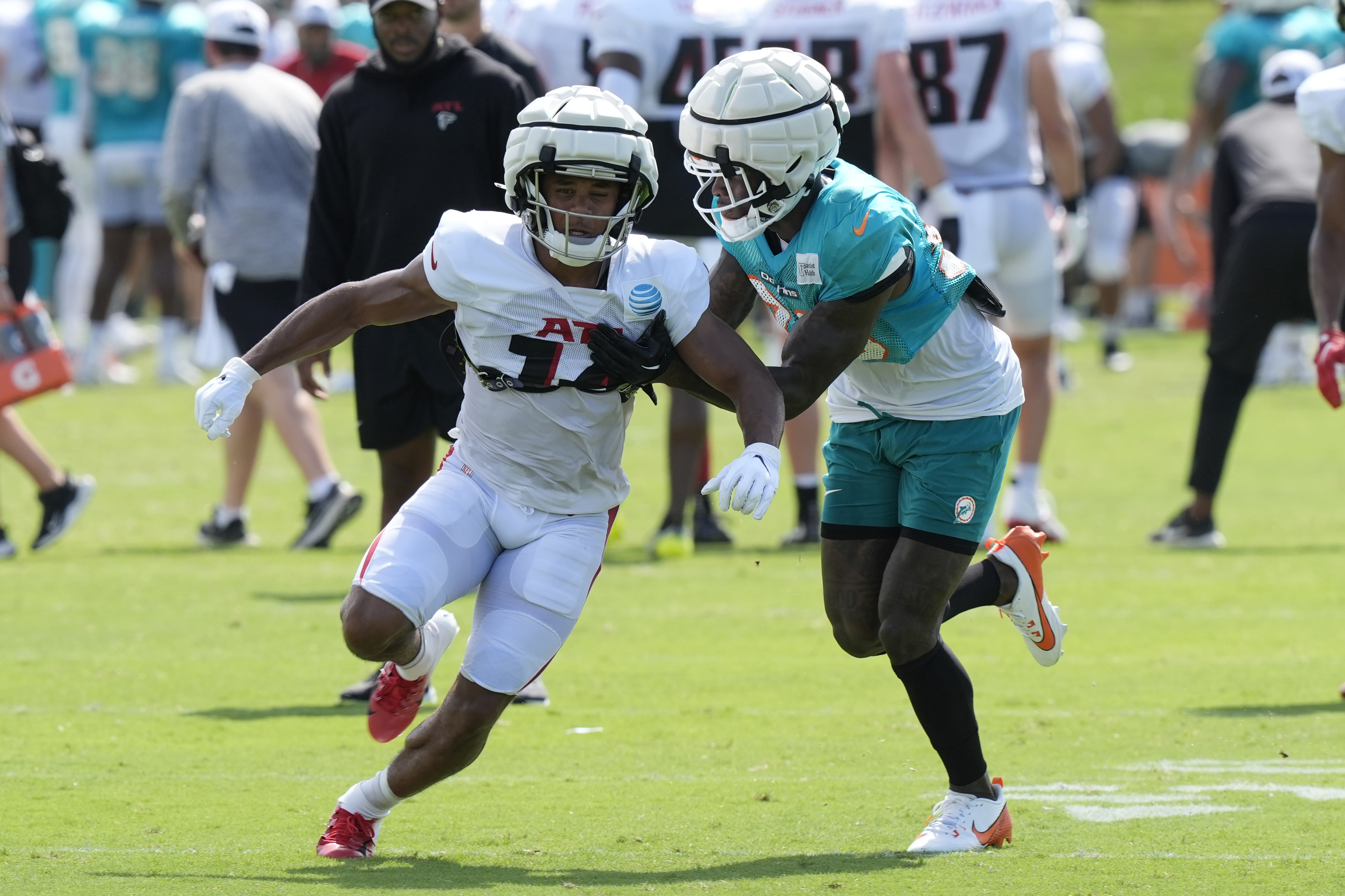 CORRECTS FIRST NAME TO RONDALE, NOT MONDALE AS ORIGINALLY SENT - Miami Dolphins cornerback Siran Neal defends Atlanta Falcons wide receiver Rondale Moore (14) during a joint NFL football practice at the team's practice facility, Tuesday, Aug. 6, 2024, in Miami Gardens, Fla. 