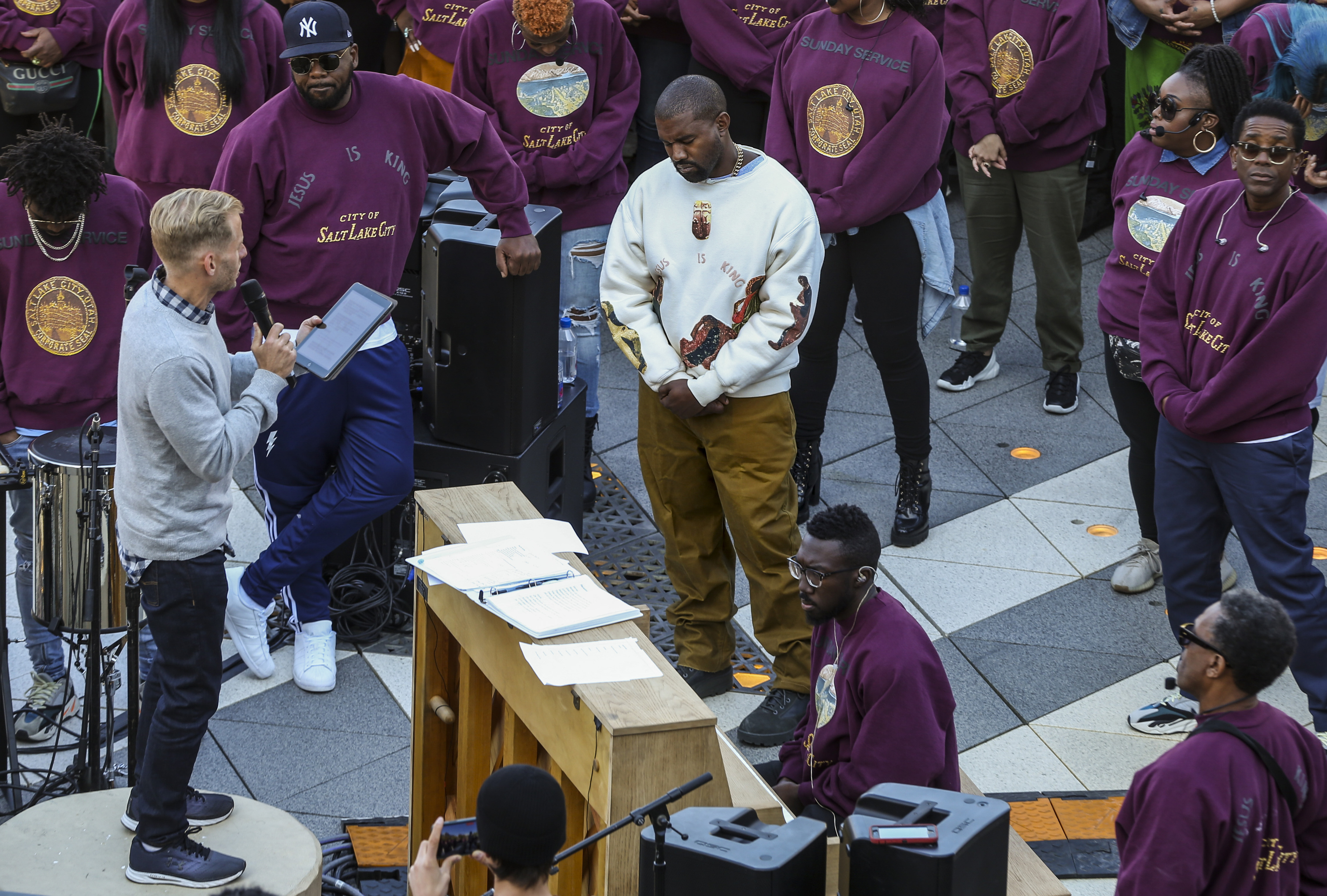 Kanye West, white sweater, bows his head during his "Sunday Service" at the Gateway in Salt Lake City on Oct. 5, 2019. Ye and Ty Dolla $ign are bringing the listening experience for their new album "Vultures 2" to Salt Lake City on Friday.