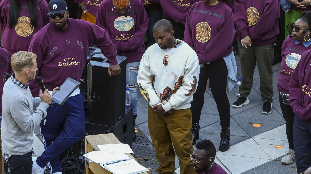 Kanye West, white sweater, bows his head during his "Sunday Service" at the Gateway in Salt Lake City on Oct. 5, 2019. Ye and Ty Dolla $ign are bringing the listening experience for their new album "Vultures 2" to Salt Lake City on Friday.