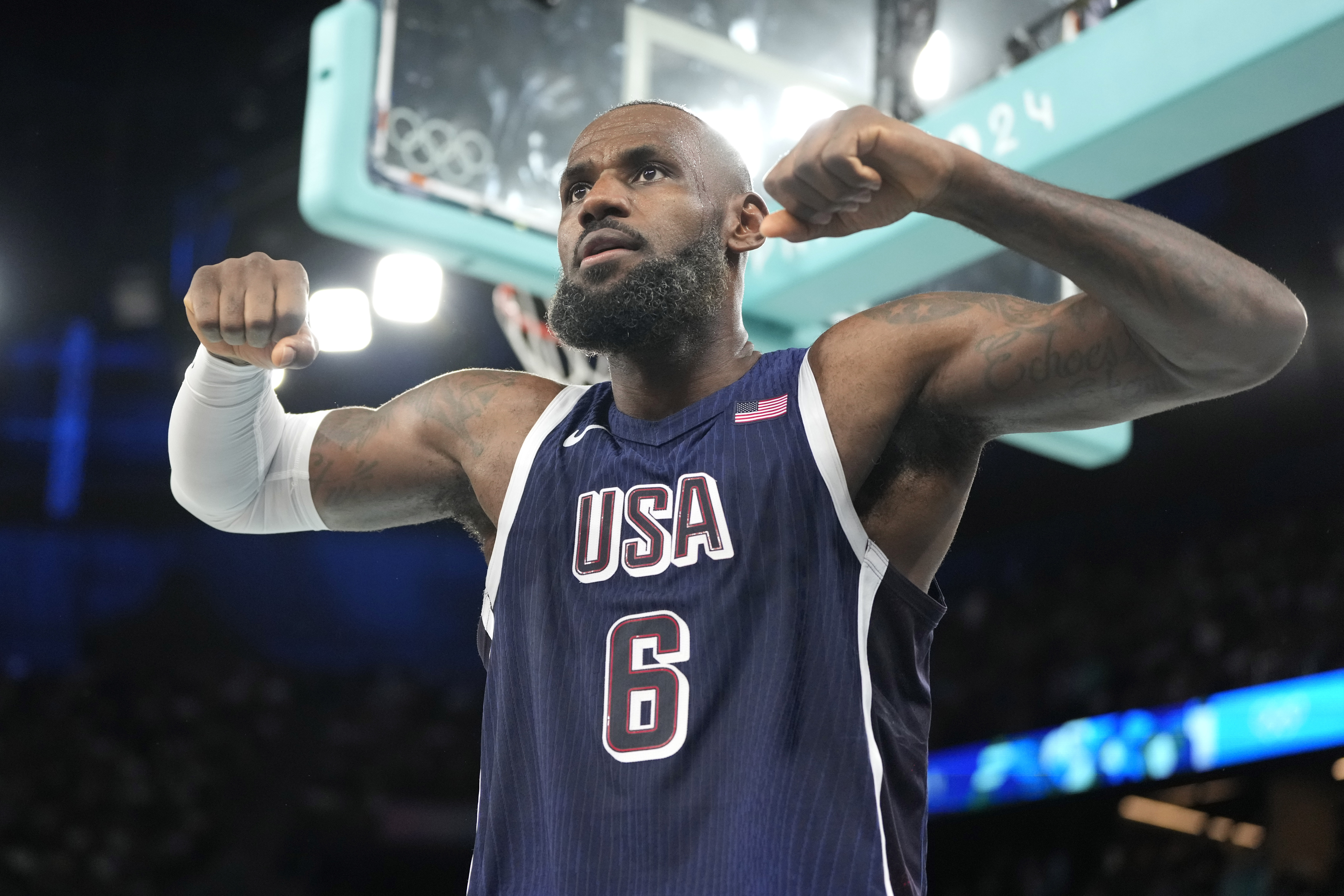 United States' LeBron James flexes after scoring during a men's basketball game against Brazil at the 2024 Summer Olympics, Tuesday, Aug. 6, 2024, in Paris, France. 
