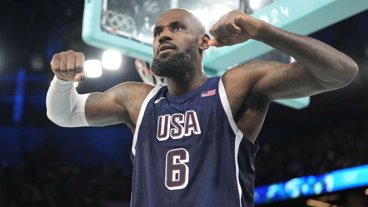 United States' LeBron James flexes after scoring during a men's basketball game against Brazil at the 2024 Summer Olympics, Tuesday, Aug. 6, 2024, in Paris, France.