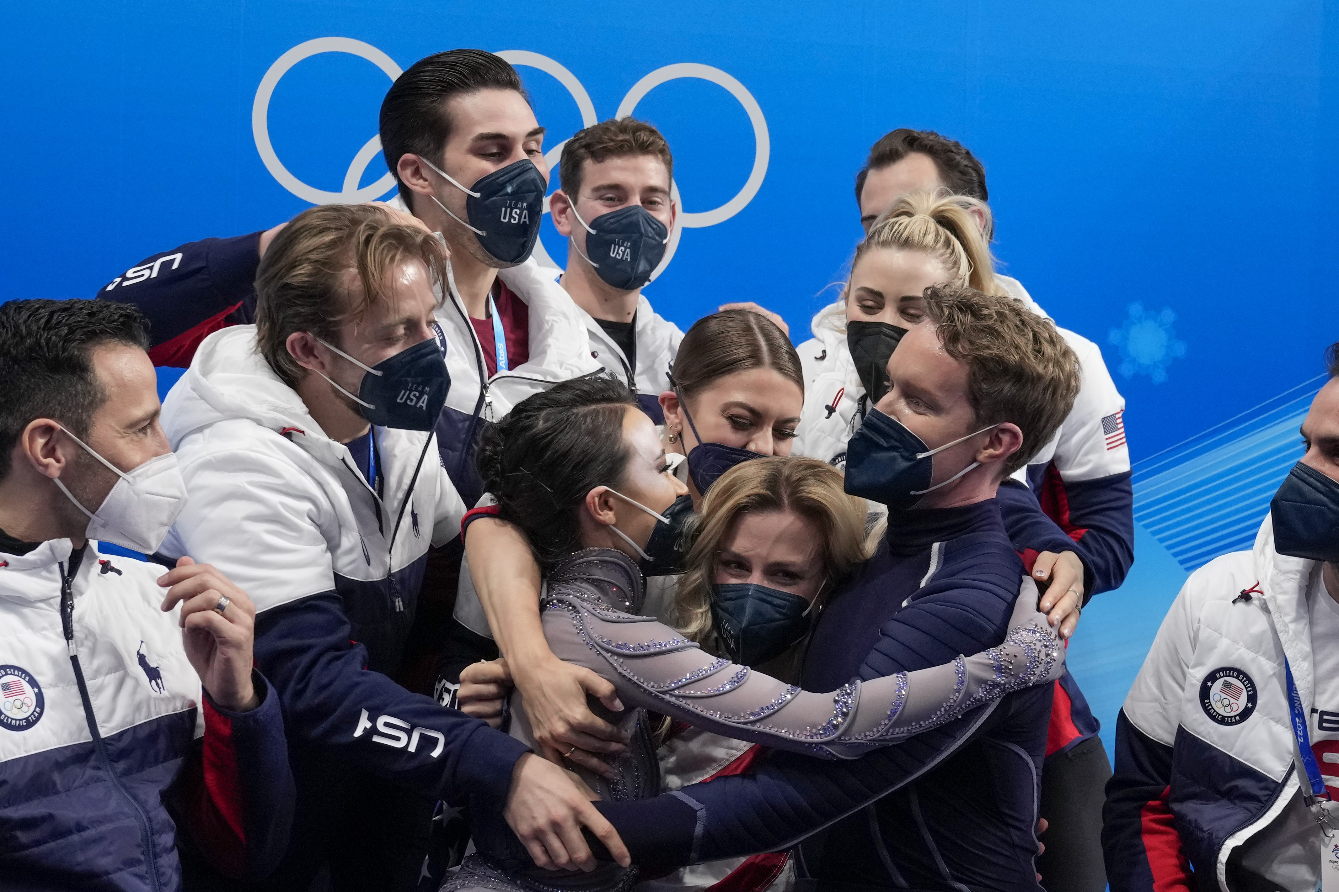 FILE - Madison Chock and Evan Bates, of the United States, reacts after the team ice dance program during the figure skating competition at the 2022 Winter Olympics, Monday, Feb. 7, 2022, in Beijing.The United States figure skating team was formally confirmed as the 2022 Beijing Olympics champion by a sports court ruling. It opens the way to the skaters getting their medals at a presentation ceremony at the Paris Summer Games. 