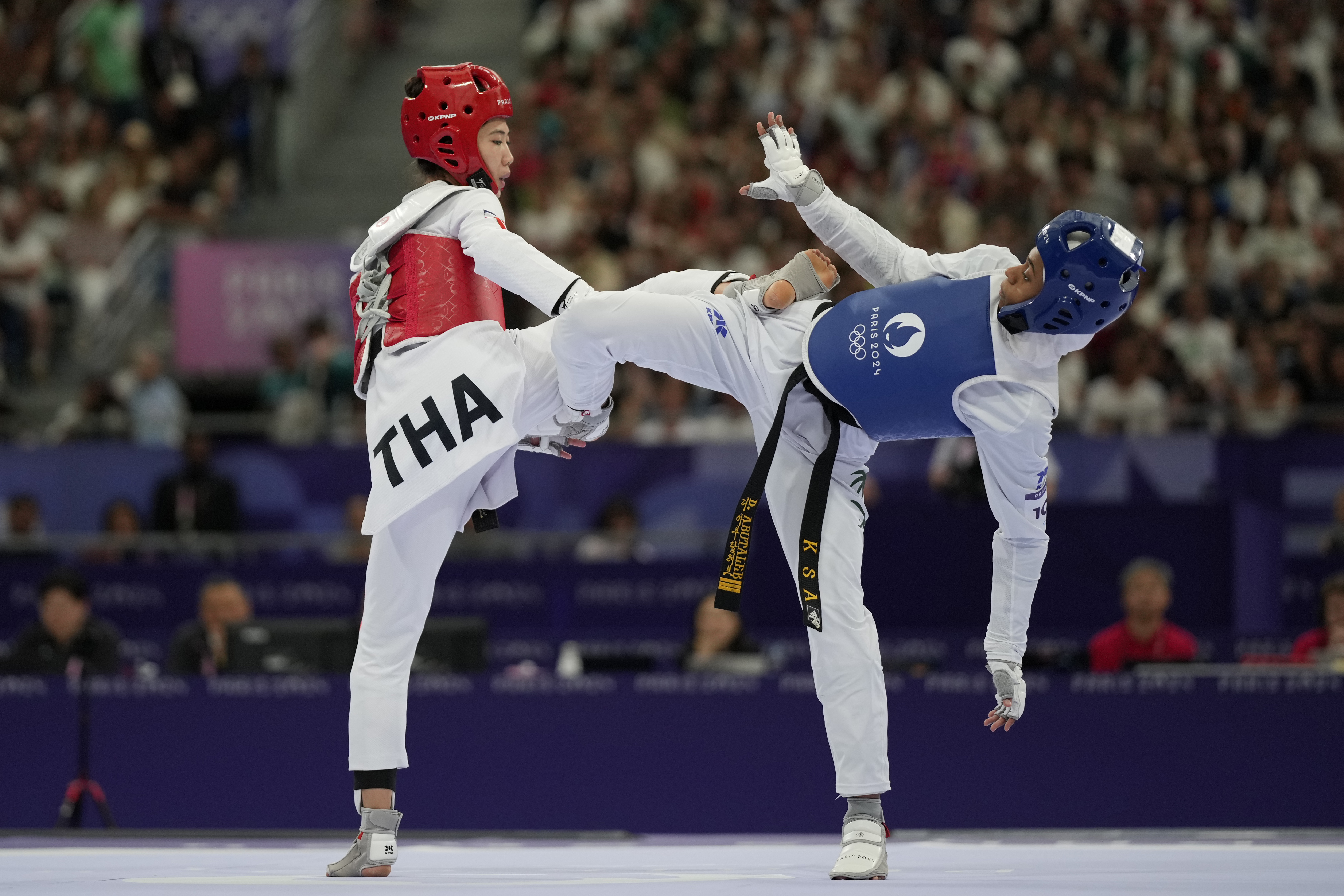 Saudi Arabia's Dunya Ali M Abutaleb competes with Thailand's Panipak Wongpattankit in a women's 49kg Taekwondo quarterfinal match during the 2024 Summer Olympics, at the Grand Palais, Wednesday, Aug. 7, 2024, in Paris, France. 