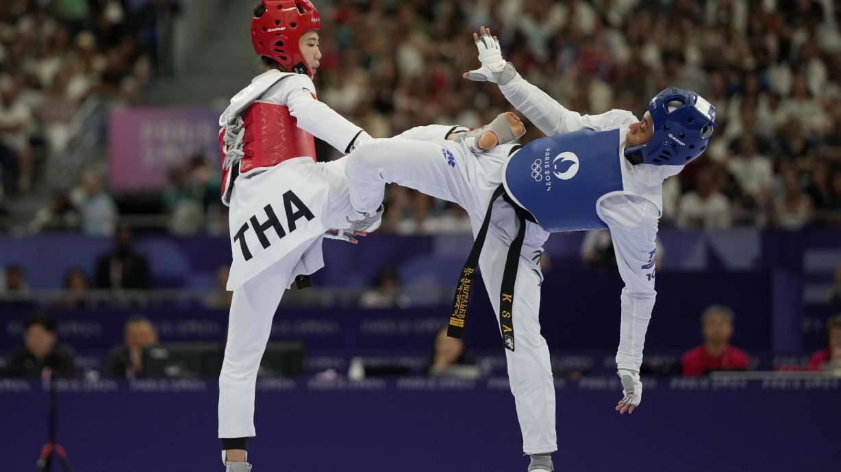 Saudi Arabia's Dunya Ali M Abutaleb competes with Thailand's Panipak Wongpattankit in a women's 49kg Taekwondo quarterfinal match during the 2024 Summer Olympics, at the Grand Palais, Wednesday, Aug. 7, 2024, in Paris, France.