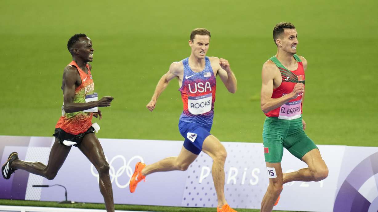 Soufiane El Bakkali, of Morocco, right, Kenneth Rooks, of the United States, center, and Abraham Kibiwot, of Kenya, competes in the men's 3000-meters steeplechase final at the 2024 Summer Olympics, Wednesday, Aug. 7, 2024, in Saint-Denis, France.