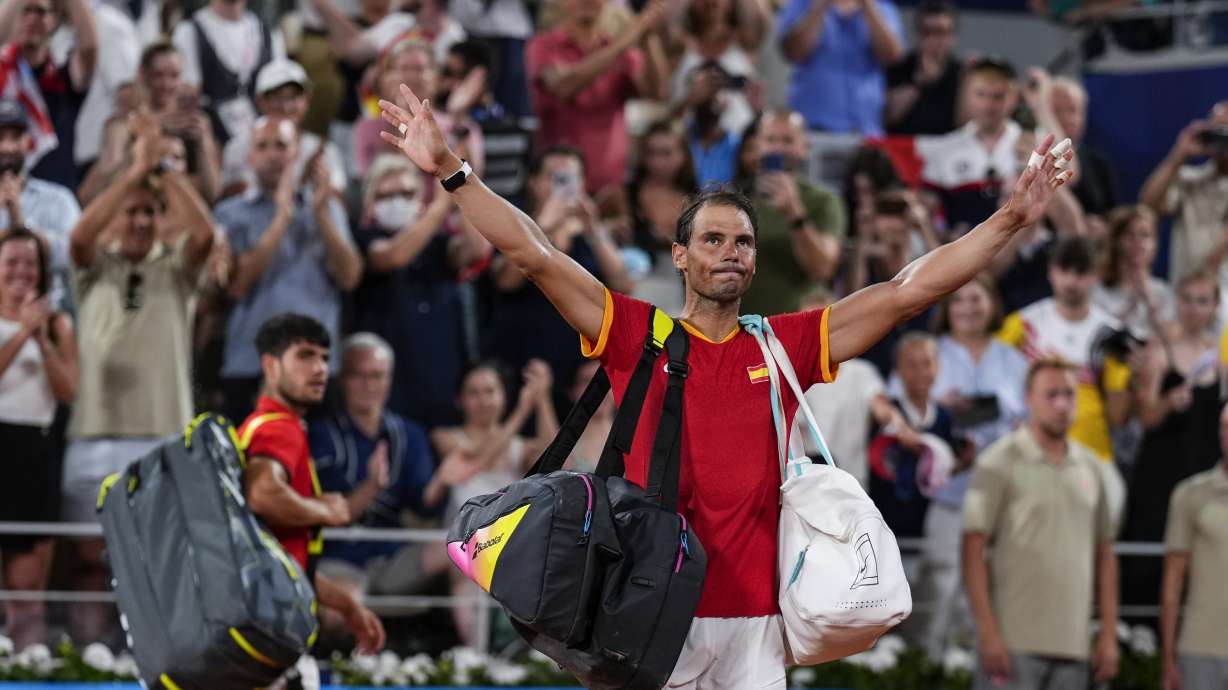 Carlos Alcaraz, left, and Rafael Nadal of Spain leave the court after losing against Austin Krajicek and Rajeev Ram of the USA during the men's doubles quarter-final tennis competition at the Roland Garros stadium, at the 2024 Summer Olympics, Wednesday, July 31, 2024, in Paris, France.