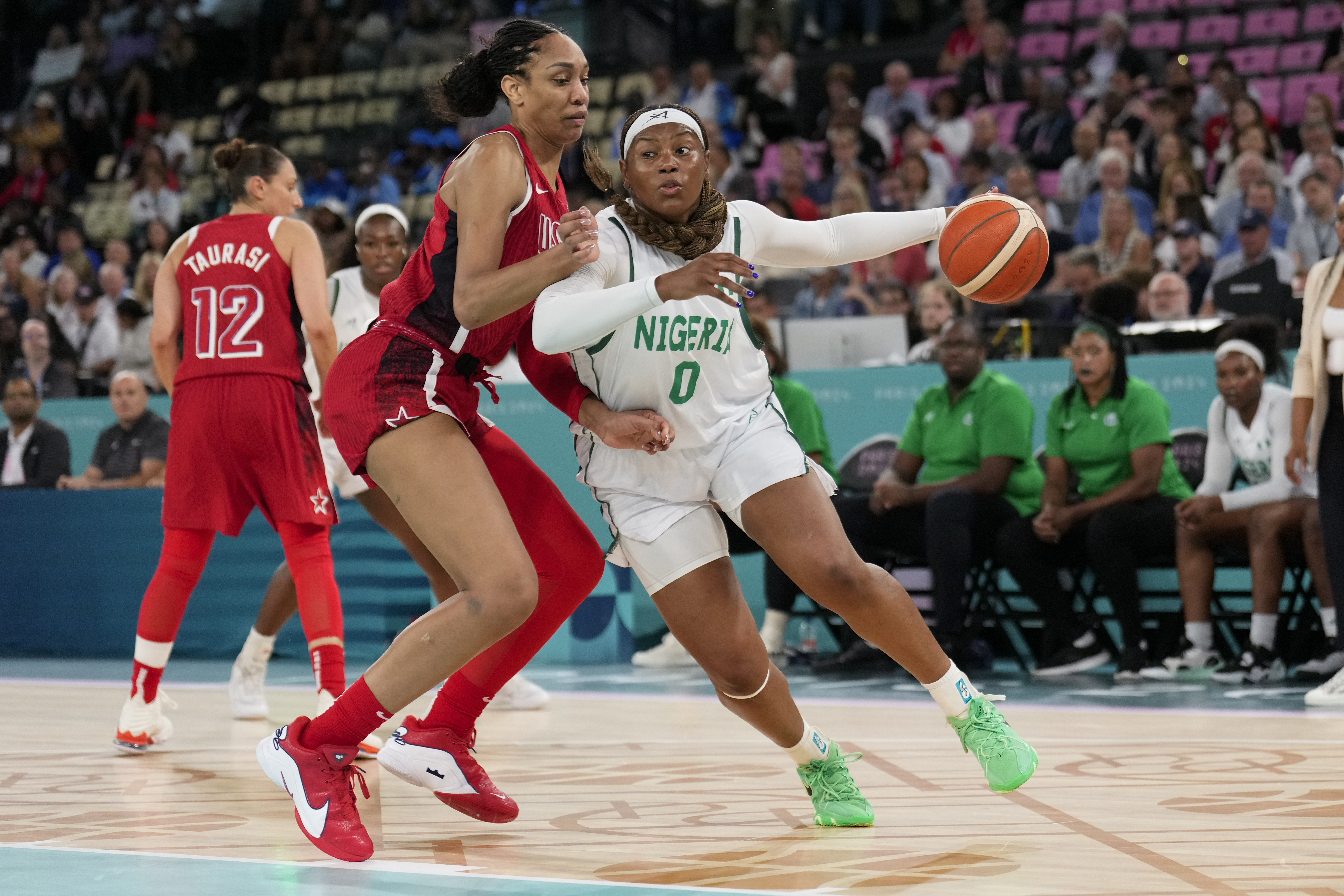 Amy Okonkwo (0), of Nigeria, drives on United States' A'ja Wilson (9) during a women's quarterfinal game at Bercy Arena at the 2024 Summer Olympics, Wednesday, Aug. 7, 2024, in Paris, France.
