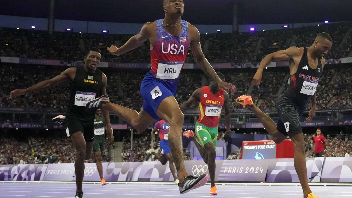 Quincy Hall, left, of the United States, beats Matthew Hudson-Smith, of Britain, to win the men's 400-meter final at the 2024 Summer Olympics, Wednesday, Aug. 7, 2024, in Saint-Denis, France.