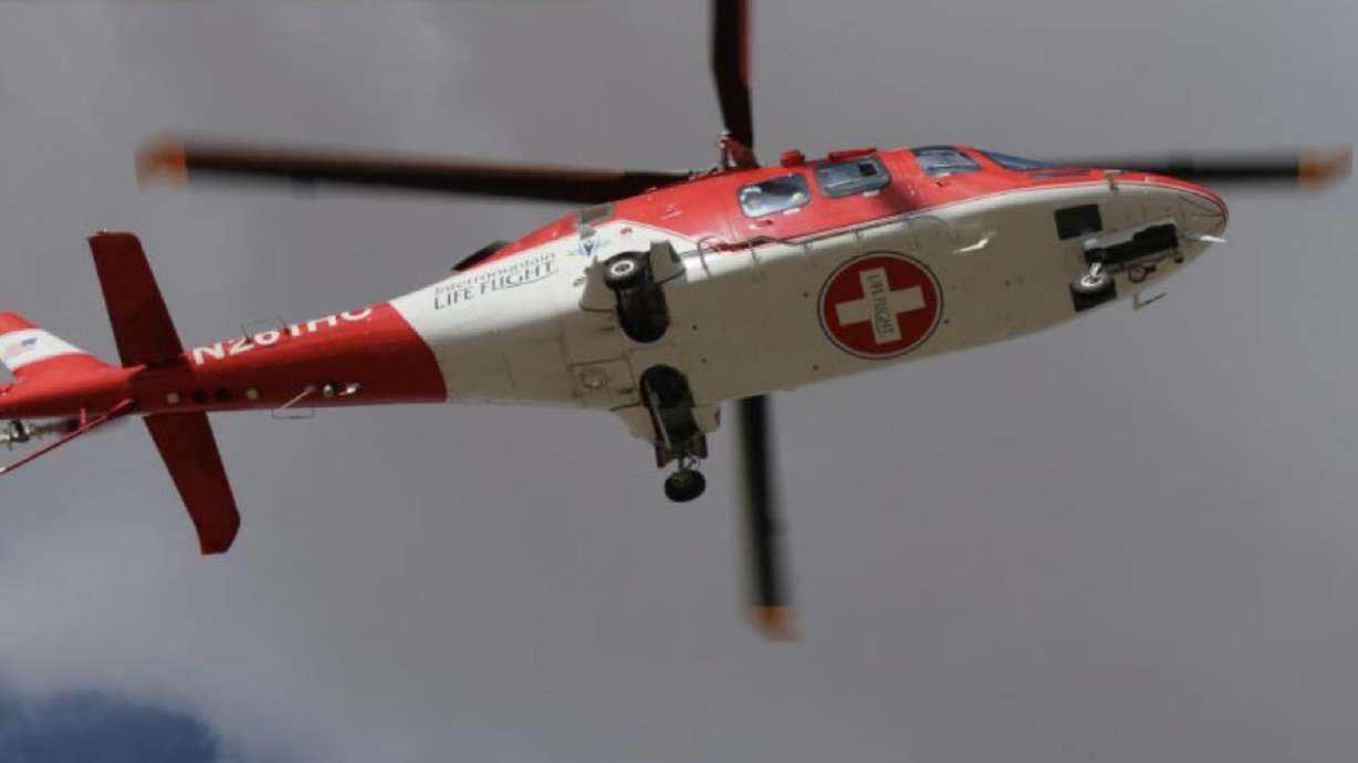 A young child was airlifted to the hospital Tuesday evening after being pinned by a water container while riding in the back of a pickup truck in the Beryl area of western Iron County.