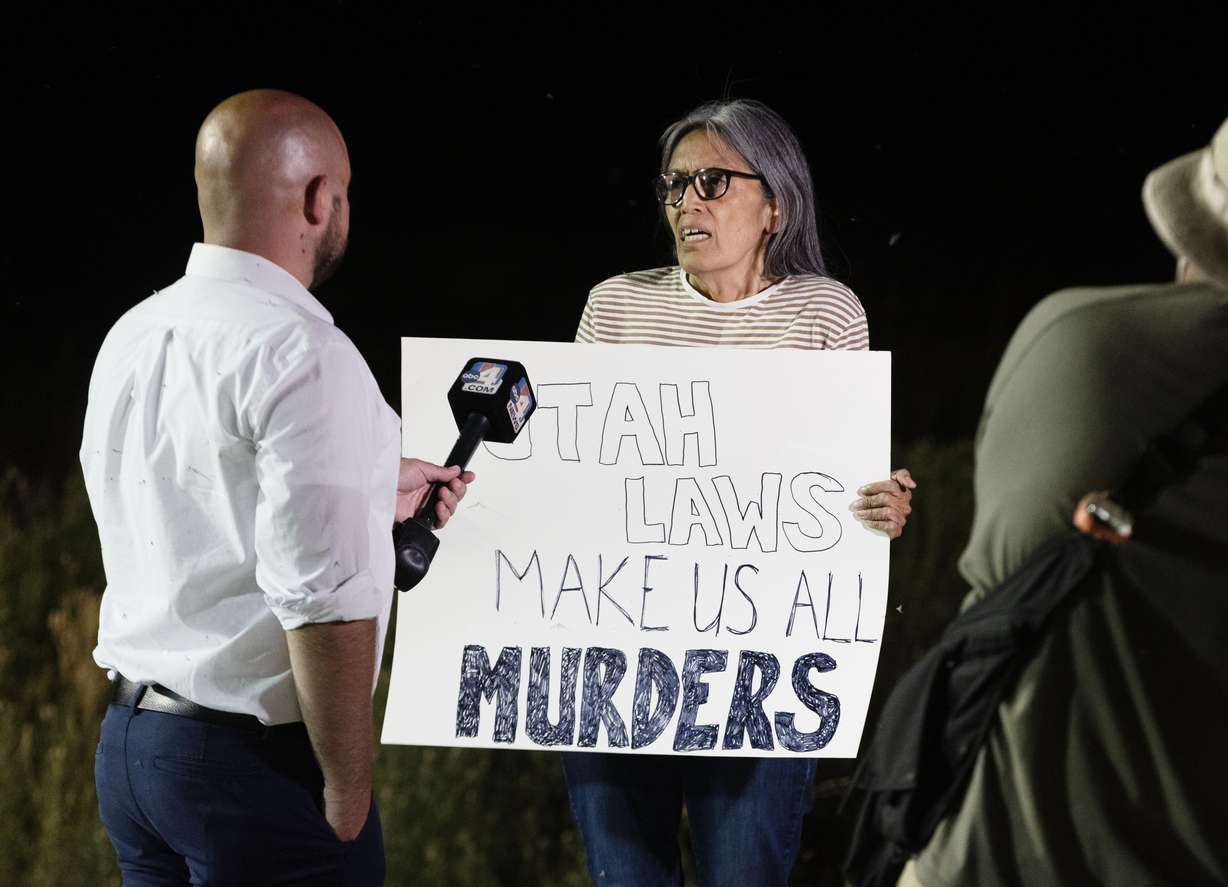 Protester Janell Wilson, from Layton, is interviewed by media during a gathering held in a Free Speech Zone established by the Utah Department of Corrections near the Utah State Correctional Facility in Salt Lake City before the execution of Taberon Honie on Wednesday.