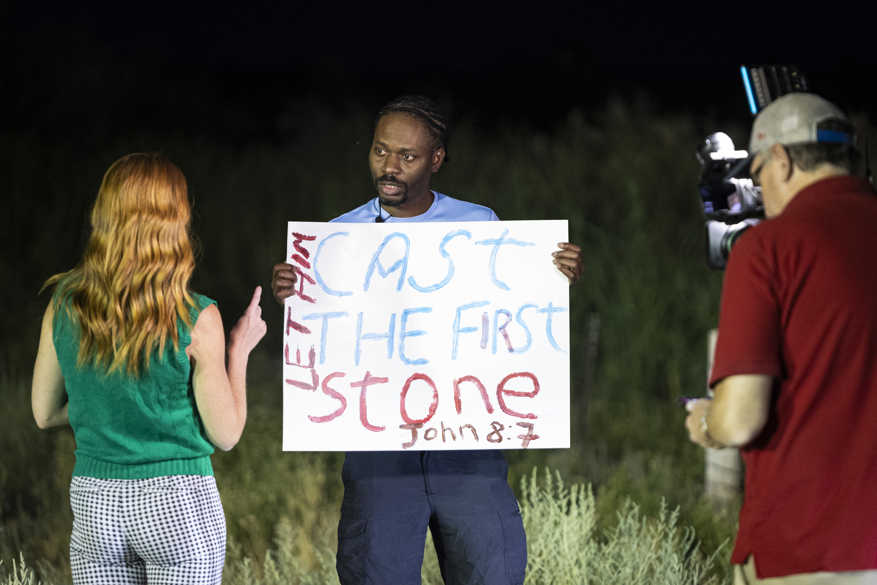 Rony Charles, of Salt Lake City, is interviewed by members of the media during a gathering held in a free speech zone near the Utah State Correctional Facility in Salt Lake City before the execution of Taberon Honie on Wednesday. - Isaac Hale, Deseret News