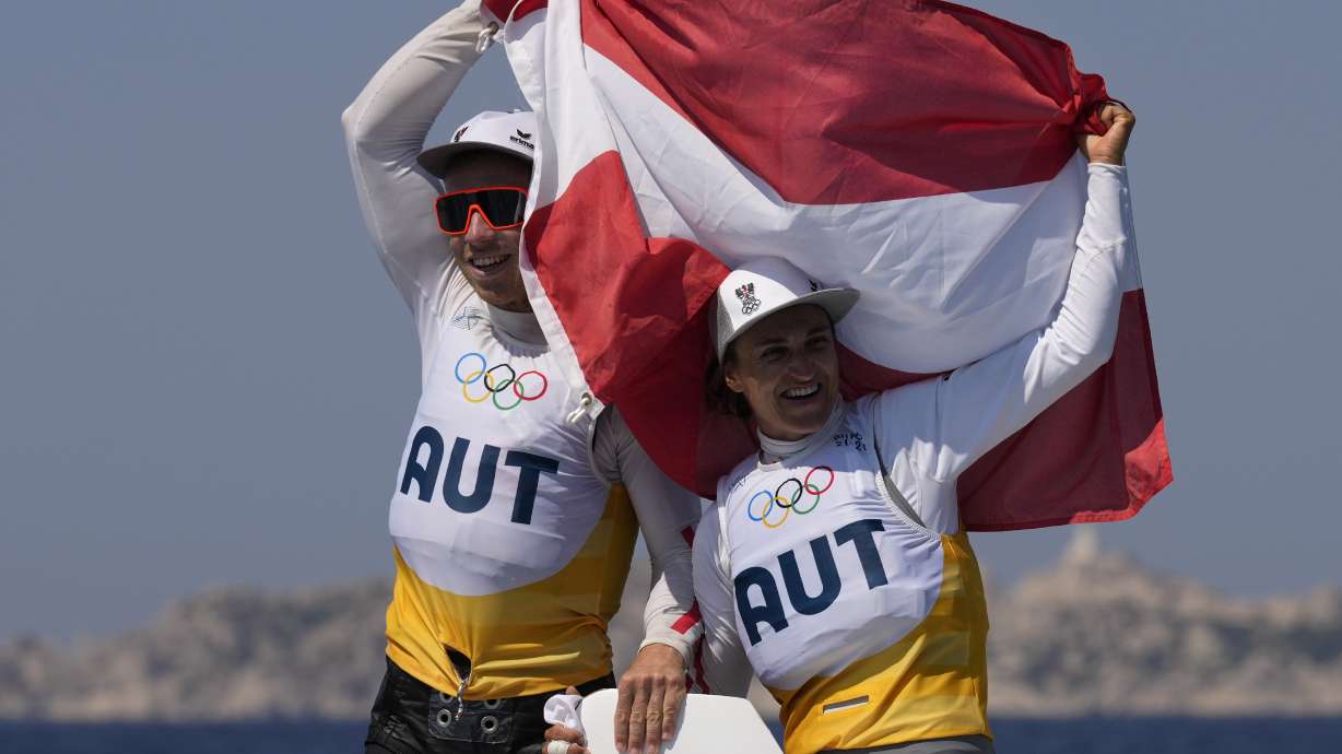 Lara Vadlau and Lukas Maehr of Austria celebrate after the 470 mixed dinghy medal race during the 2024 Summer Olympics, Thursday, Aug. 8, 2024, in Marseille, France.