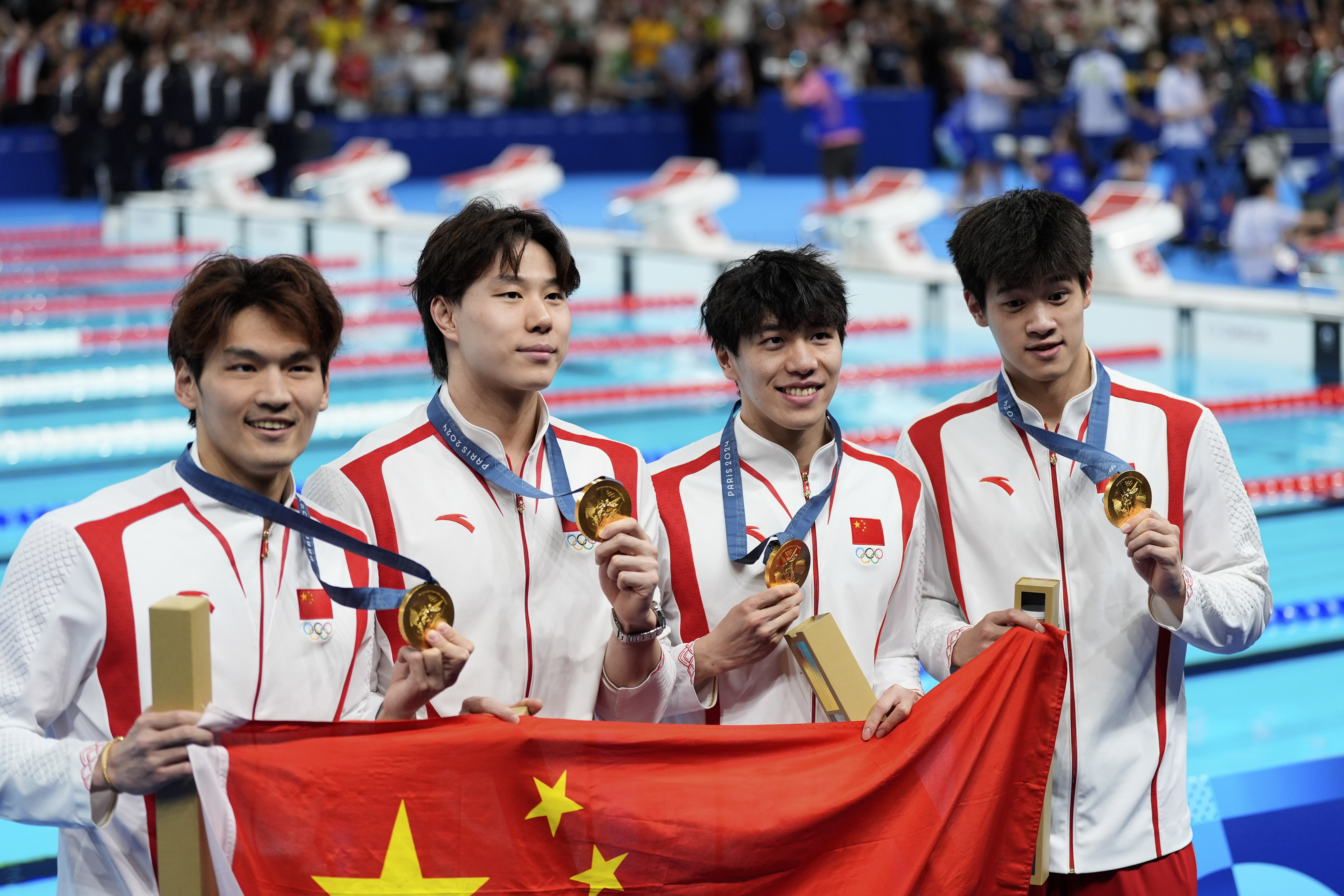 China's Xu Jiayu, Qin Haiyang, Sun Jiajun, and Pan Zhanle pose for a photo with their gold medals during the awards ceremony for the men's 4x100-meter medley relay at the Summer Olympics in Nanterre, France, Sunday, Aug. 4, 2024.