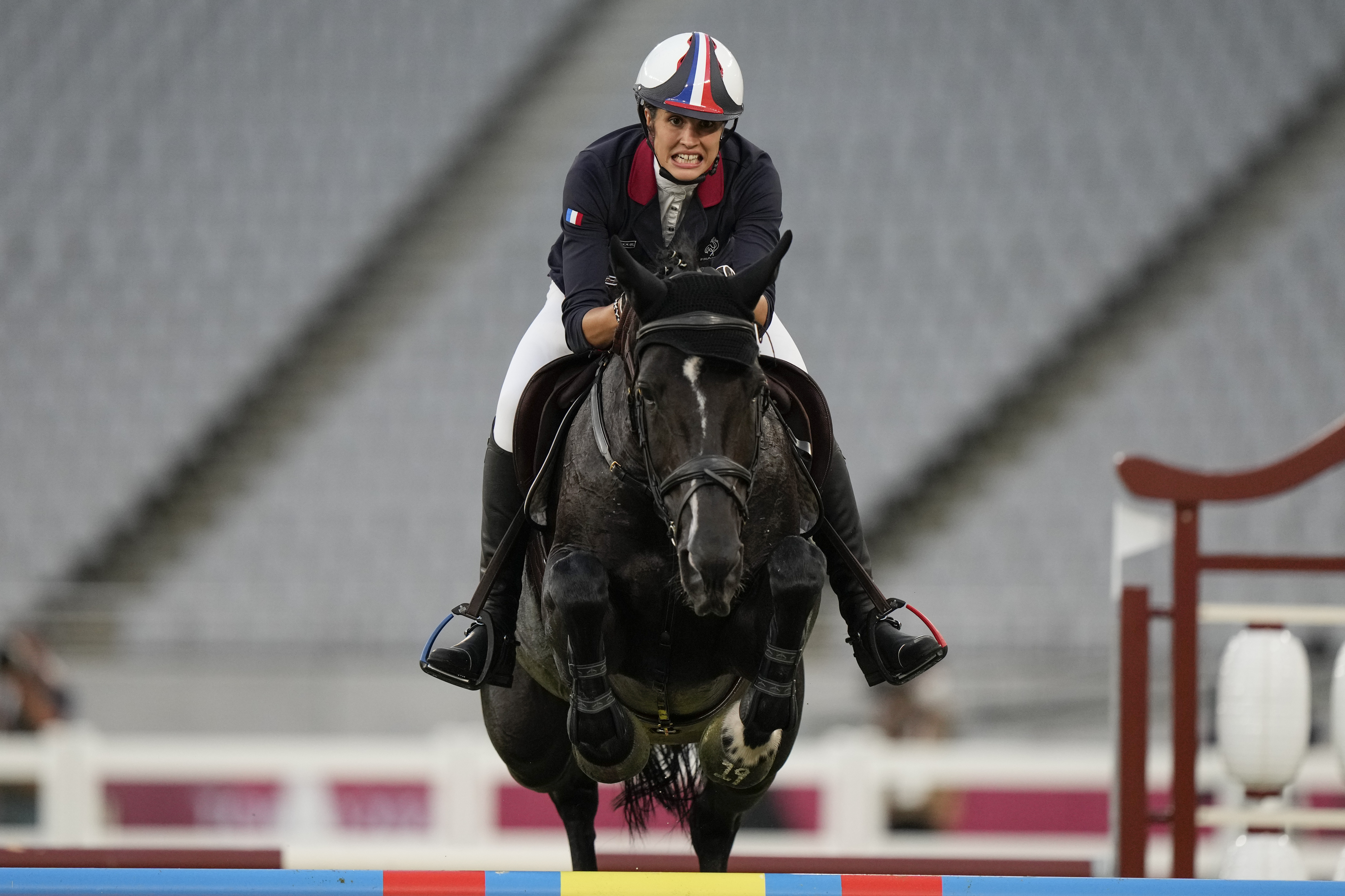 FILE - Elodie Clouvel of France competes in the horse jumping portion of the women's modern pentathlon at the 2020 Summer Olympics, Friday, Aug. 6, 2021, in Tokyo, Japan. On Sunday at the Paris Olympics, a 112-year-old cavalry officer will ride for the last time. The sport of modern pentathlon, a niche outlier at the Olympics, is getting rid of its horses after more than a century, and a notorious incident when a coach struck a horse at the last Games.