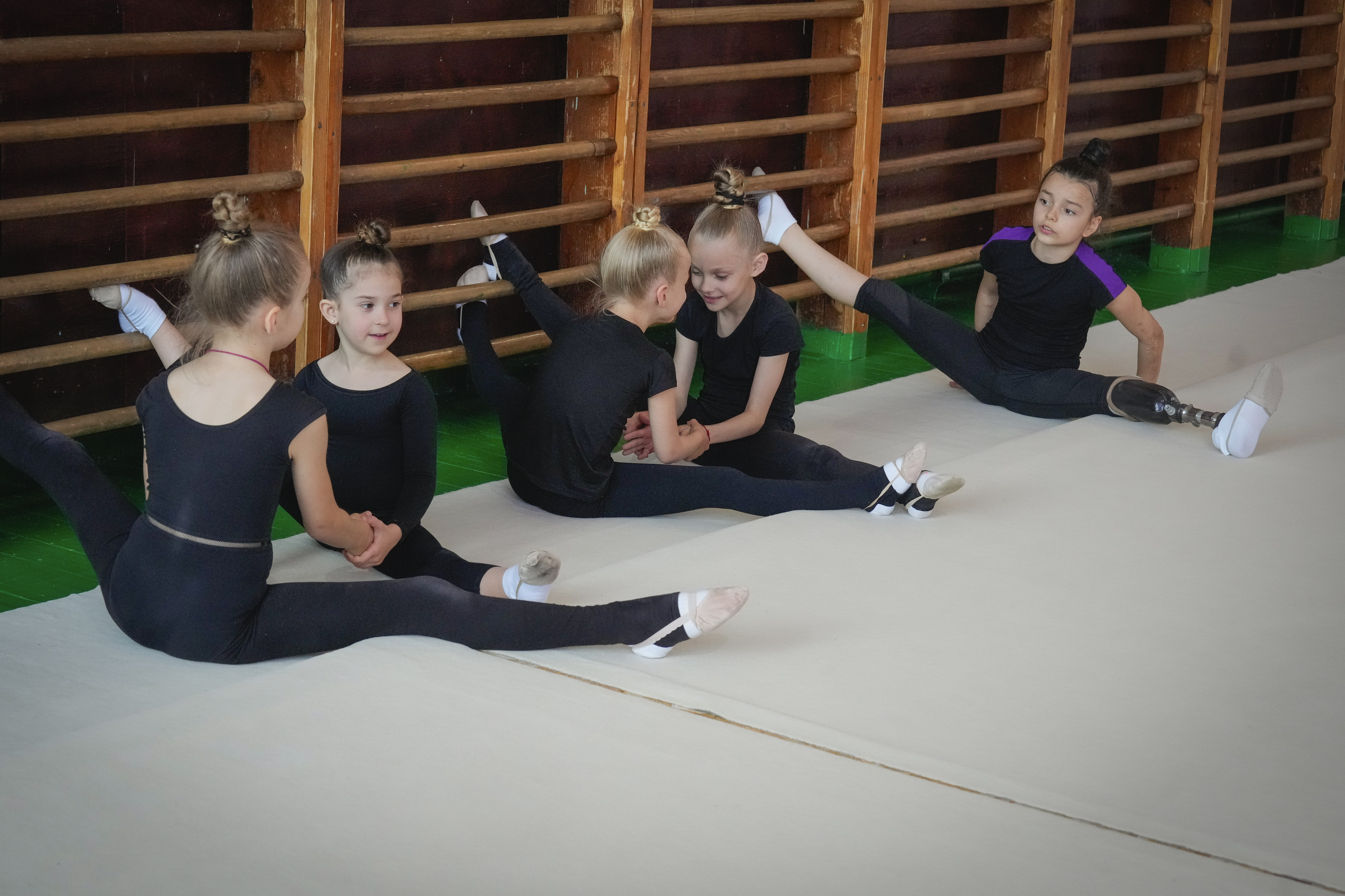 Oleksandra Paskal, an 8-year old girl with a prosthetic leg, practices rhythmic gymnastics with other girls in Chornomorsk, Odesa region, Ukraine, Thursday, May 16, 2024. When Oleksandra first took to the mat as a 4-year-old, her rhythmic gymnastics coach saw nothing but potential in a sport where the Olympics is the ultimate goal. Then a Russian missile crushed her summer house in the southern Odesa region, burying her beneath the debris and severing her left leg.