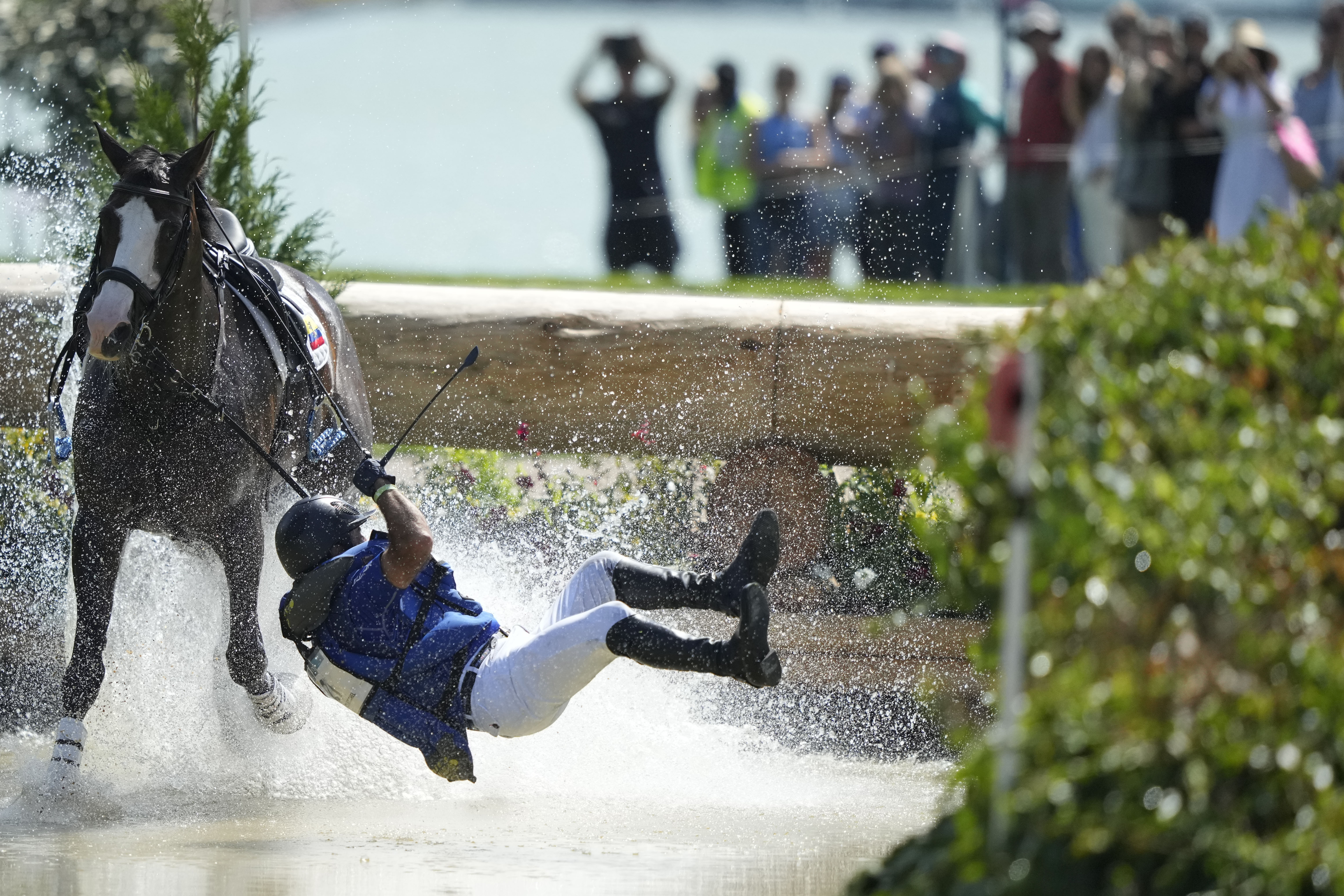 Ecuador's Ronald Zabala G., riding, Forever Young Wundermaske, fall off their horse during the Equestrian Cross Country competition at Chateau de Versailles for the 2024 Summer Olympics, Sunday, July 28, 2024, in Versailles, France. 