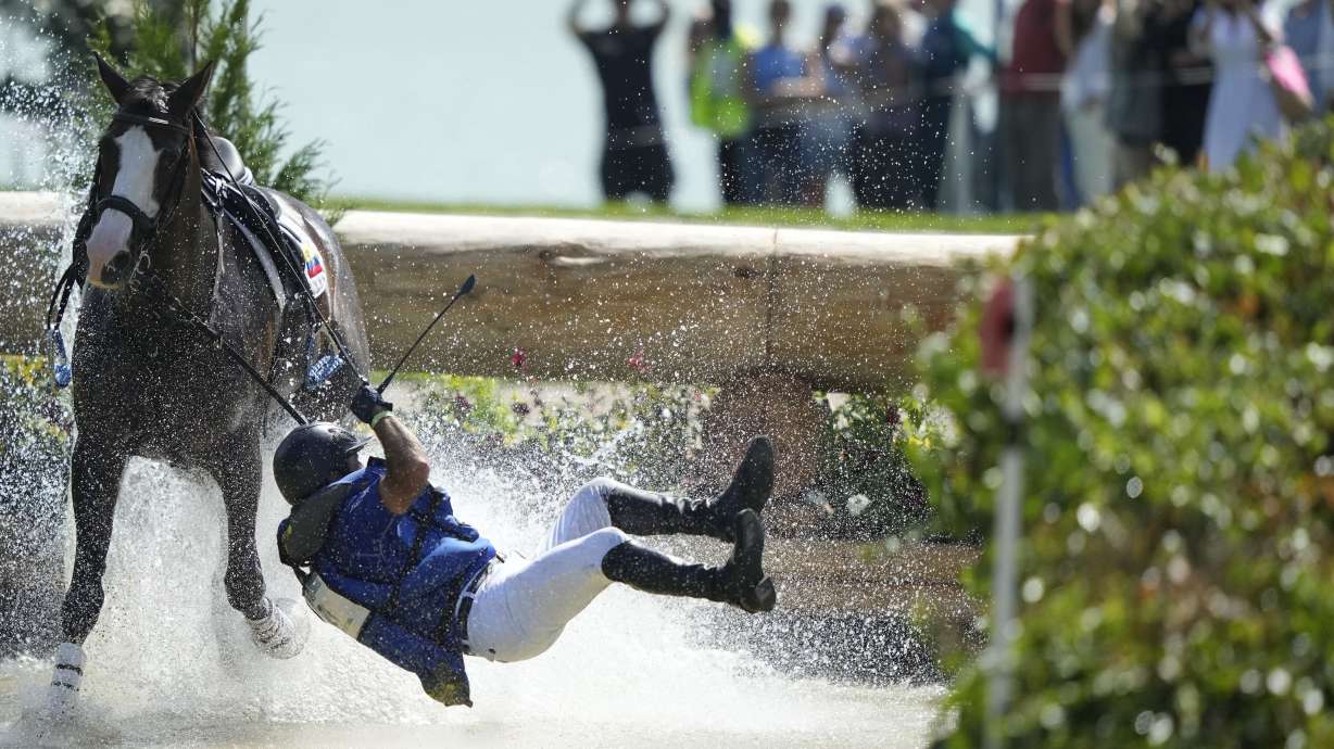 Ecuador's Ronald Zabala G., riding, Forever Young Wundermaske, fall off their horse during the Equestrian Cross Country competition at Chateau de Versailles for the 2024 Summer Olympics, Sunday, July 28, 2024, in Versailles, France.