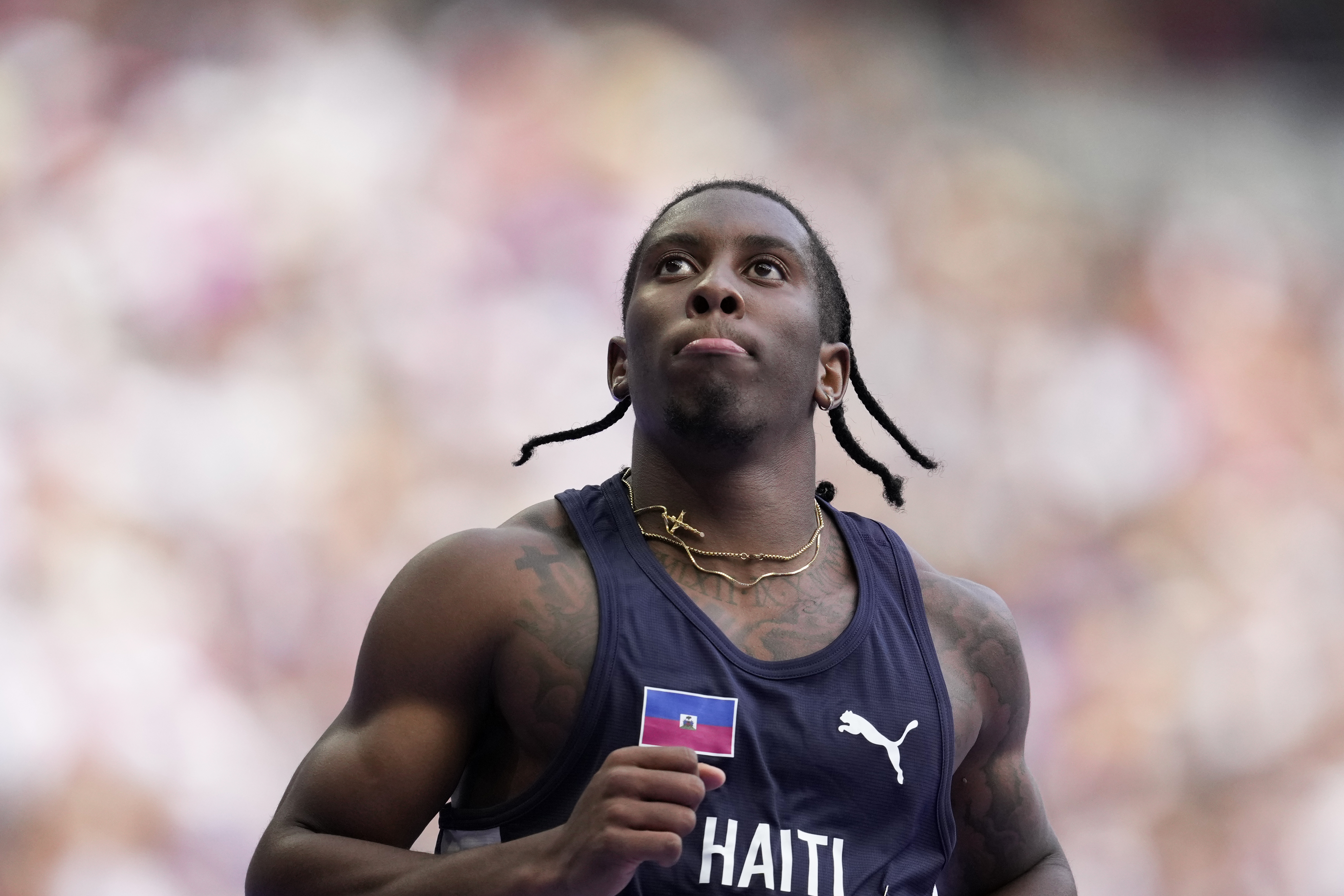 FILE - Christopher Borzor, of Haiti, reacts after qualifying in a men's 100 meters preliminary round heat at the 2024 Summer Olympics, Saturday, Aug. 3, 2024, in Saint-Denis, France. 