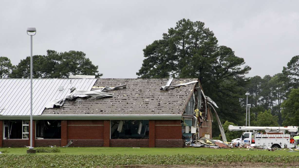 Parts of Springfield Middle School lay on the ground after being ripped off by a tornado spawned by Tropical Storm Debby, in Lucama, N.C., Thursday.