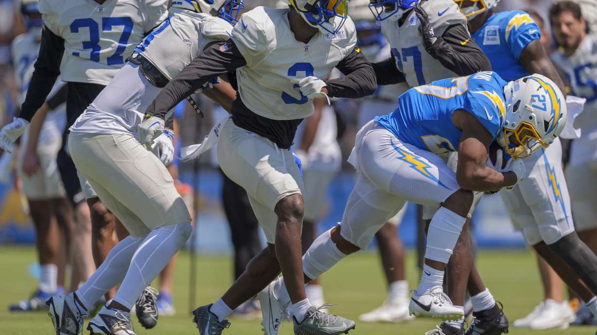 Los Angeles Chargers running back J.K. Dobbins runs with the ball during NFL football practice at The Bolt in El Segundo, Calif., on Sunday, August 4, 2024. The Rams and Chargers are having joint practices.