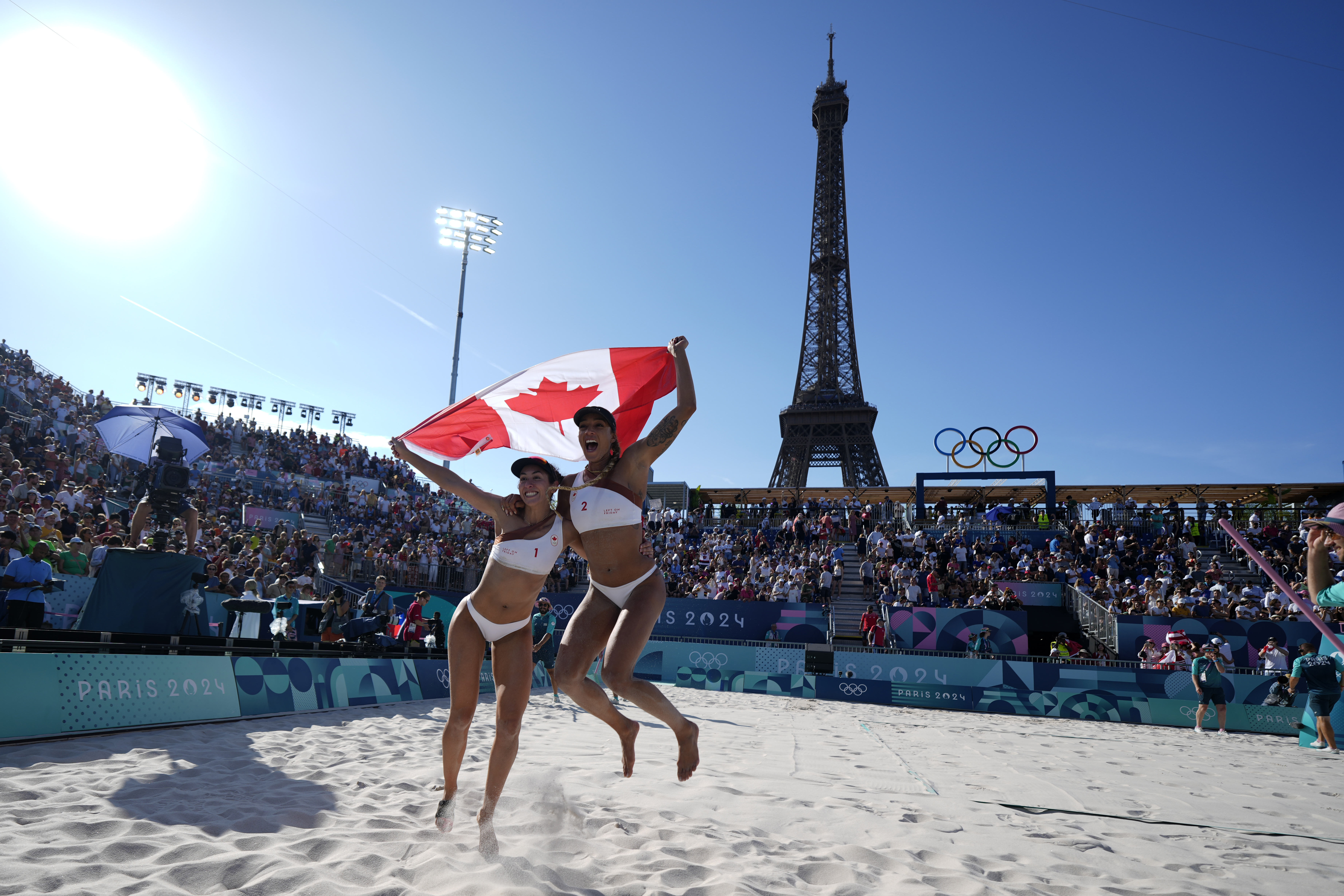 Canada's Melissa Humana-Paredes, left, and Brandie Wilkerson celebrate a women's semifinal beach volleyball match victory over Switzerland at the 2024 Summer Olympics, Thursday, Aug. 8, 2024, in Paris, France. 