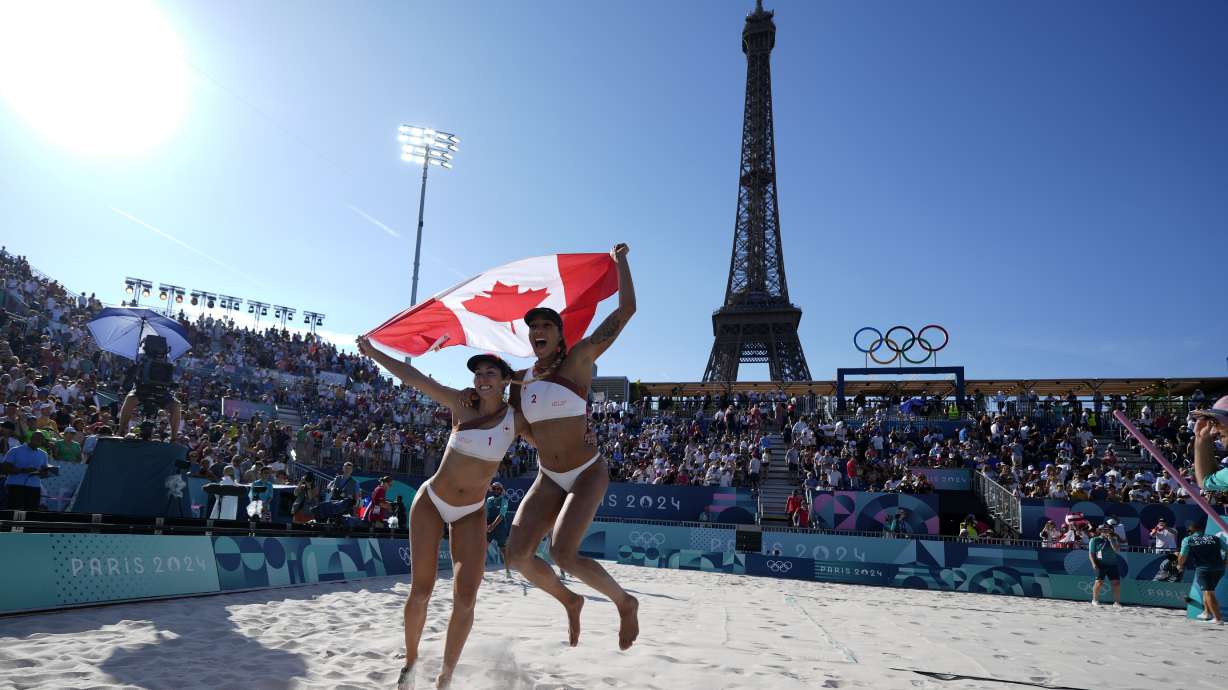 Canada's Melissa Humana-Paredes, left, and Brandie Wilkerson celebrate a women's semifinal beach volleyball match victory over Switzerland at the 2024 Summer Olympics, Thursday, Aug. 8, 2024, in Paris, France.