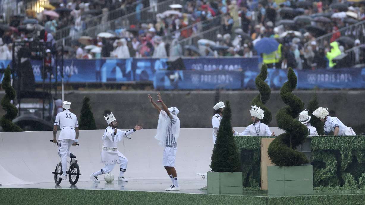 People perform during the opening ceremony of the 2024 Summer Olympics, Friday, July 26, 2024, in Paris, France.