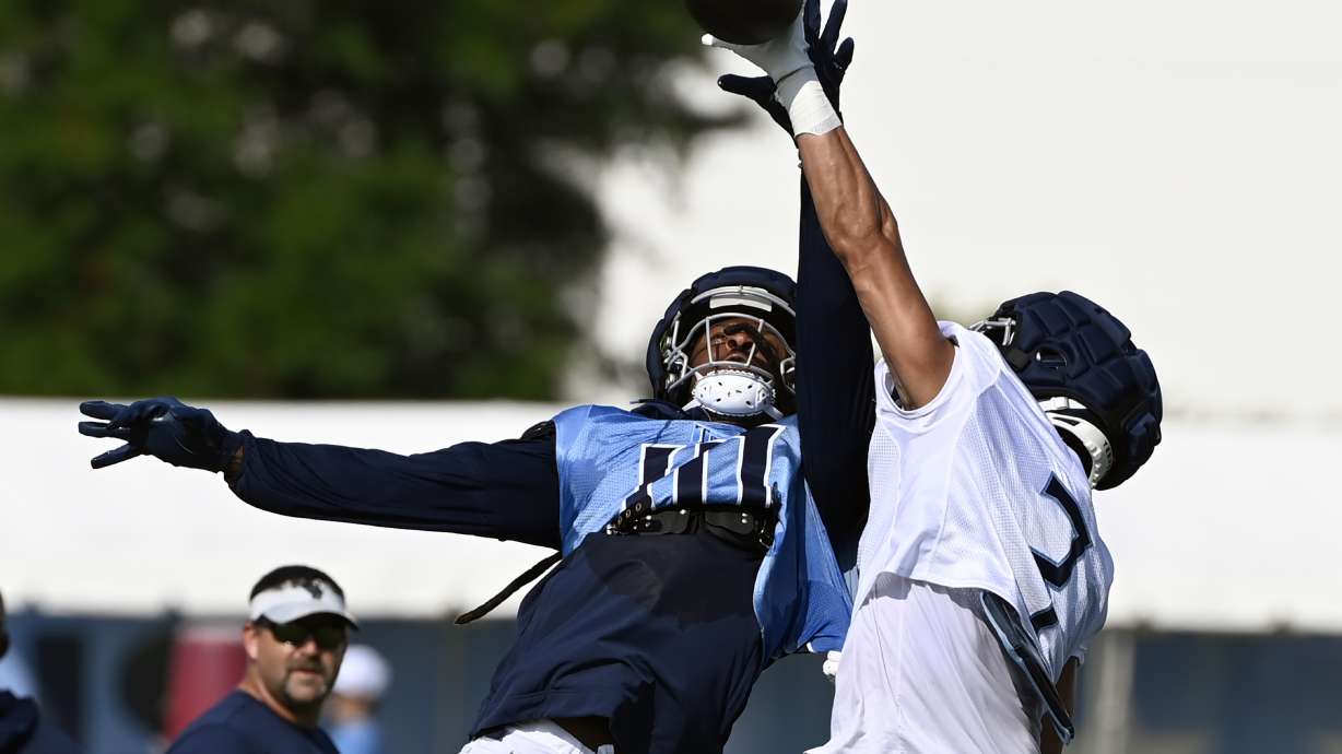Tennessee Titans cornerback Caleb Farley, right, breaks up a pass intended for wide receiver DeAndre Hopkins (10) during NFL football training camp, Tuesday, July, 30, 2024, in Nashville, Tenn.