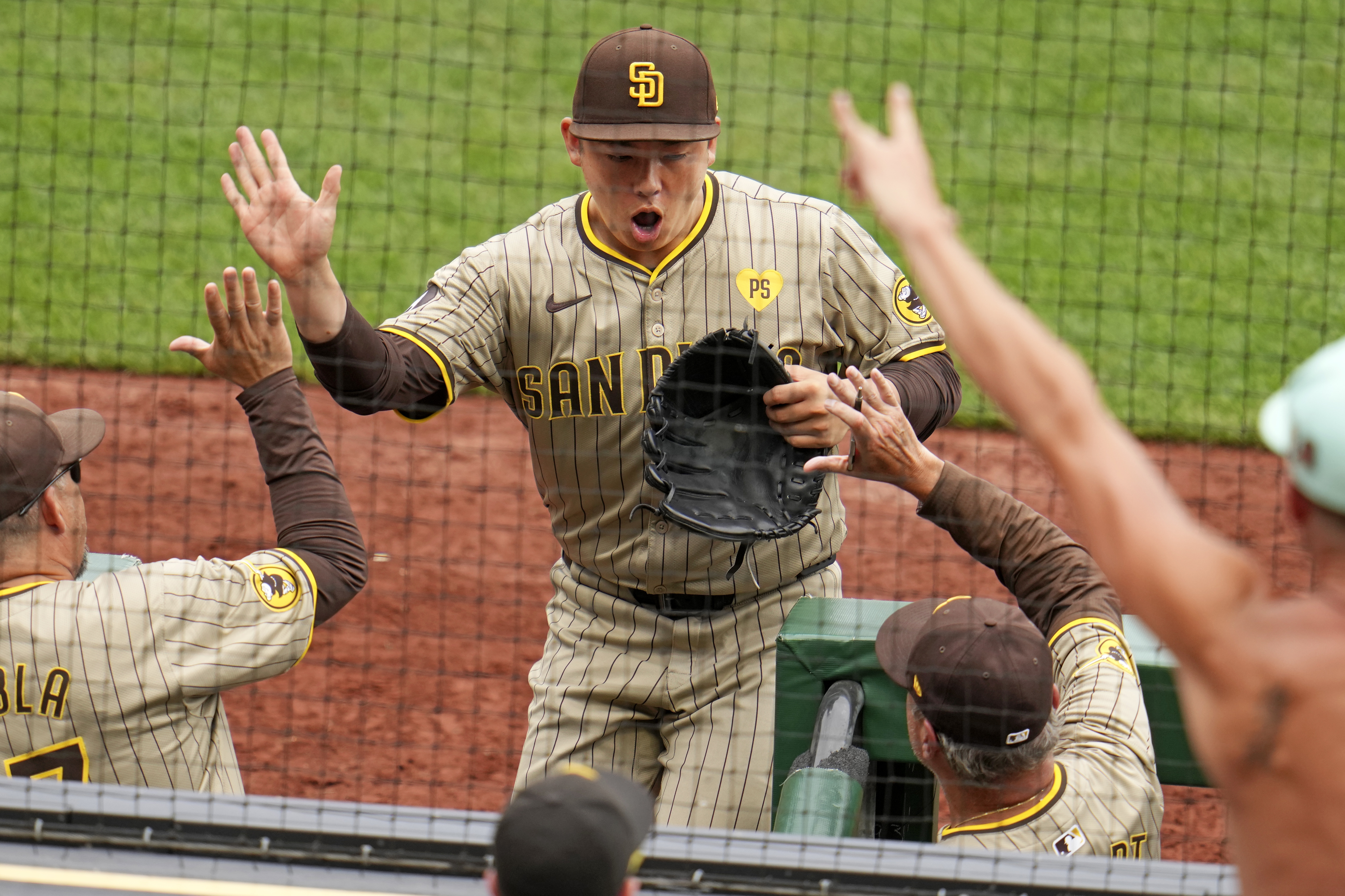 San Diego Padres relief pitcher Yuki Matsui, center, celebrates as he returns to the dugout after getting the final out of the sixth inning during a baseball game against the Pittsburgh Pirates in Pittsburgh, Thursday, Aug. 8, 2024. 
