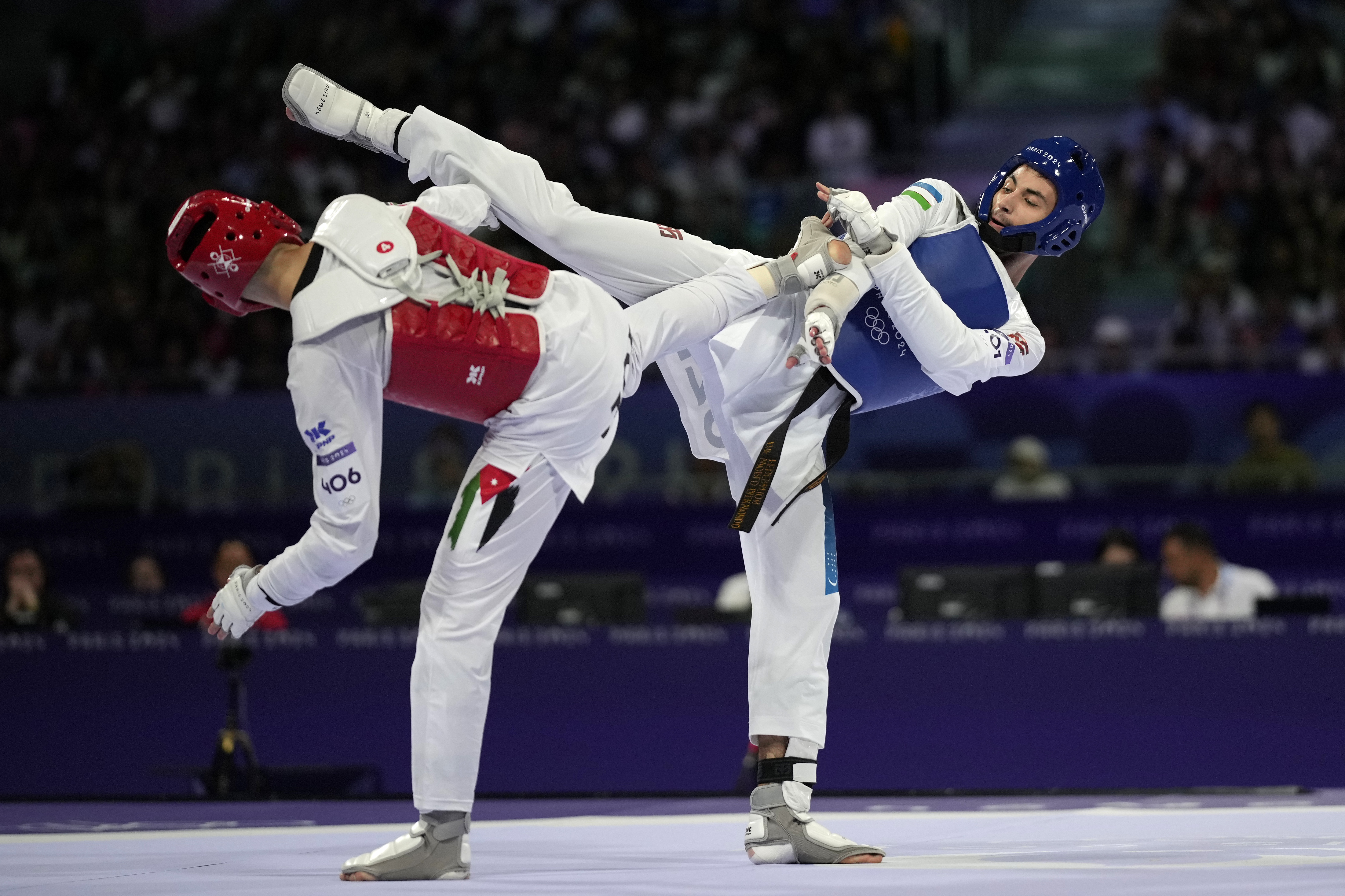 Uzbekistan's Ulugbek Rashitov competes with Jordan's Zaid Kareem in a men's 68kg Taekwondo final match during the 2024 Summer Olympics, at the Grand Palais, Thursday, Aug. 8, 2024, in Paris, France. 