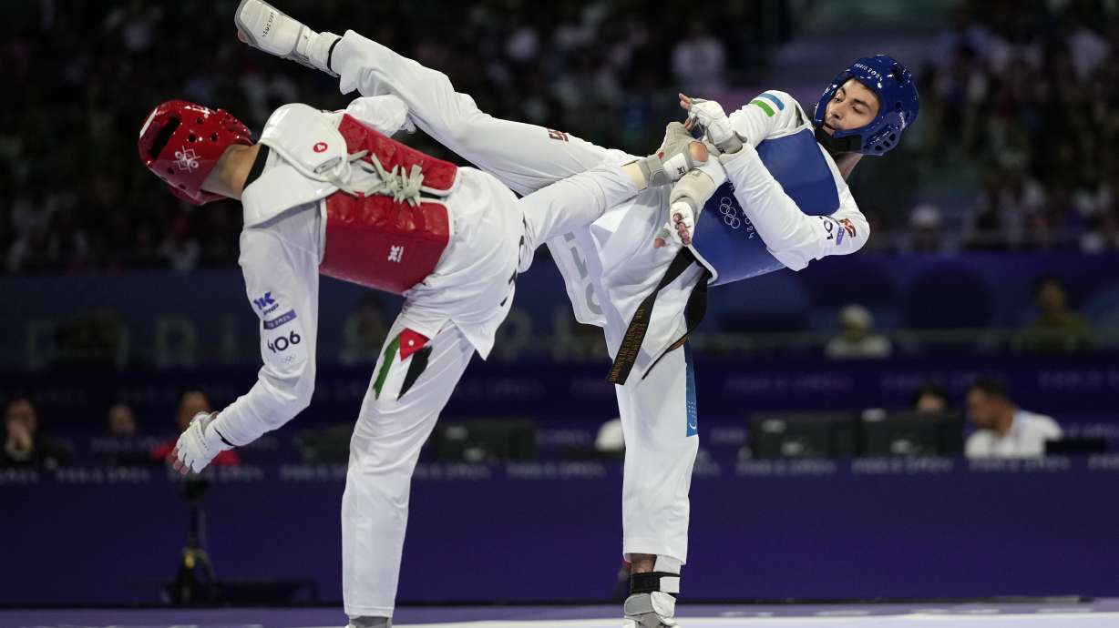 Uzbekistan's Ulugbek Rashitov competes with Jordan's Zaid Kareem in a men's 68kg Taekwondo final match during the 2024 Summer Olympics, at the Grand Palais, Thursday, Aug. 8, 2024, in Paris, France.