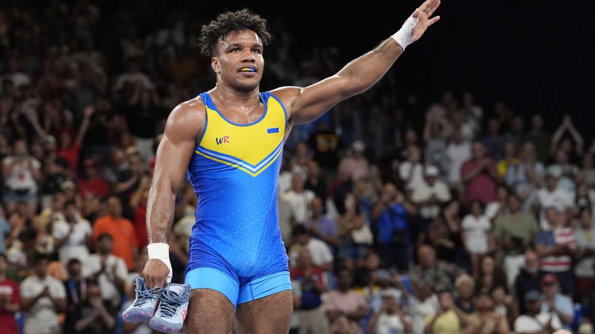 Ukraine's Zhan Beleniuk leaves his shoes in the ring as he retires after beating Poland's Arkadiusz Marcin Kulynycz during their men's Greco-Roman 87kg bronze medal wrestling match, at Champ-de-Mars Arena, during the 2024 Summer Olympics, Thursday, Aug. 8, 2024, in Paris, France.