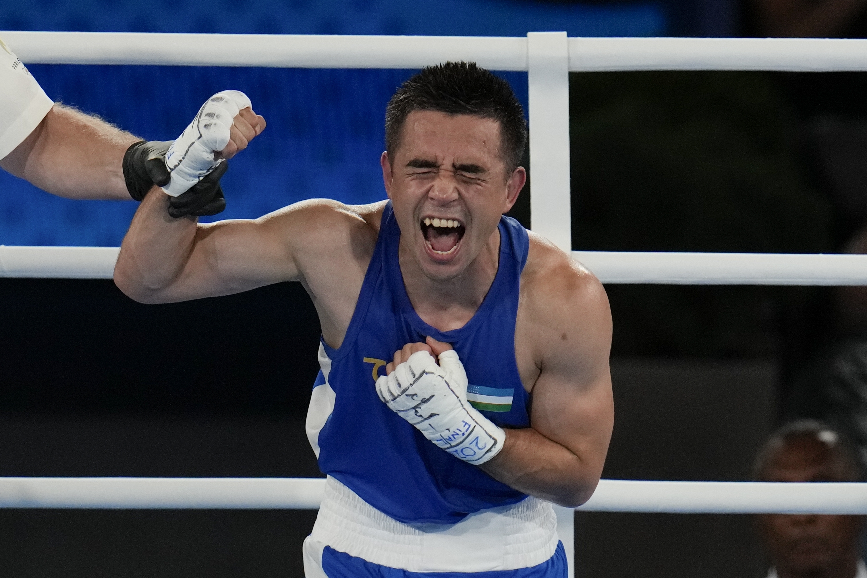 Uzbekistan's Hasanboy Dusmatov reacts after defeating France's Billal Bennama in their men's 51 kg final boxing match at the 2024 Summer Olympics, Thursday, Aug. 8, 2024, in Paris, France. 