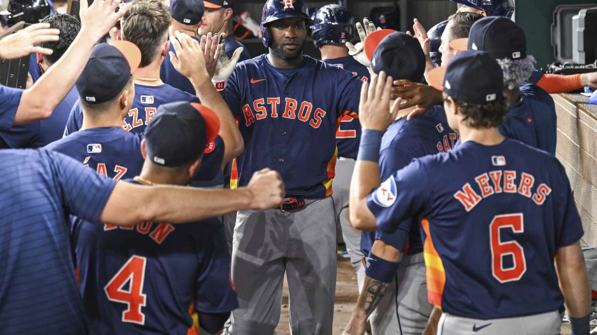 Houston Astros Yordan Alvarez, celebrates in the dugout after hitting a two run home run in the ninth inning of a baseball game against the Texas Rangers, Tuesday, Aug 6, 2024, in Arlington, Texas.