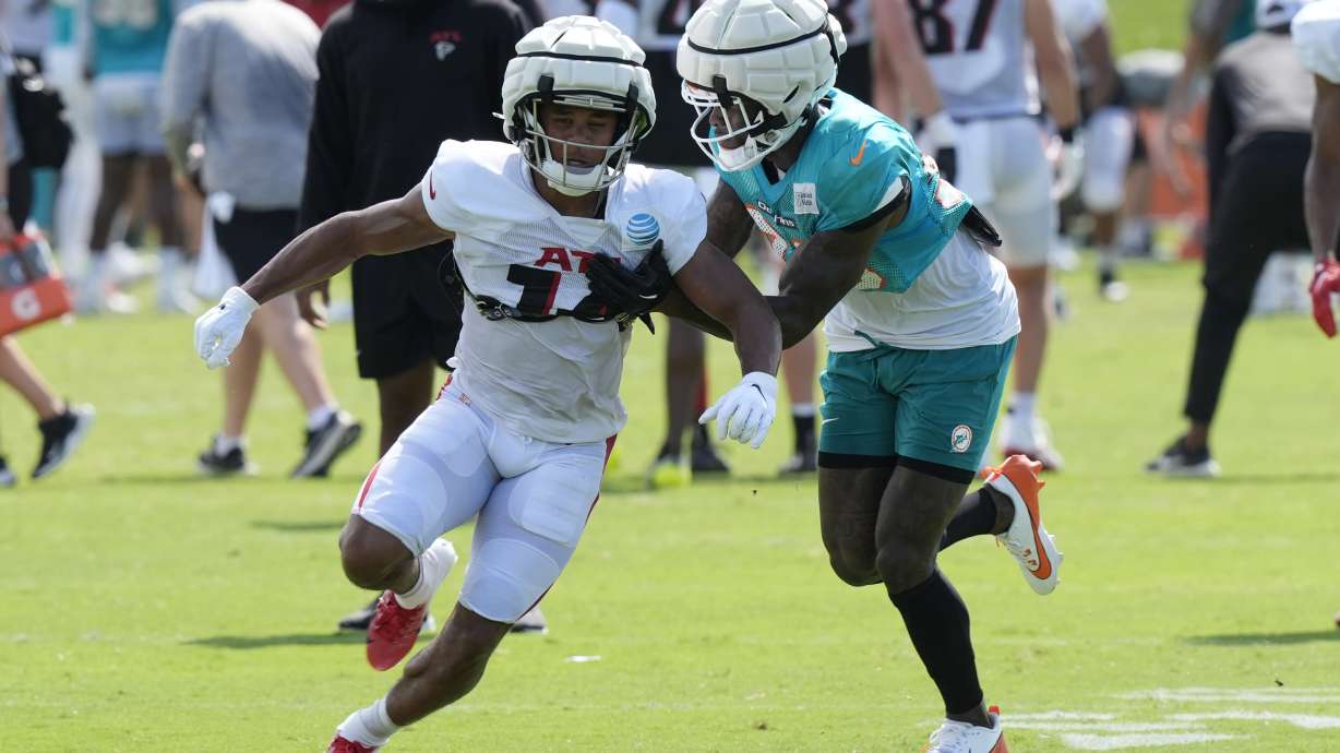 CORRECTS FIRST NAME TO RONDALE, NOT MONDALE AS ORIGINALLY SENT - Miami Dolphins cornerback Siran Neal defends Atlanta Falcons wide receiver Rondale Moore (14) during a joint NFL football practice at the team's practice facility, Tuesday, Aug. 6, 2024, in Miami Gardens, Fla.