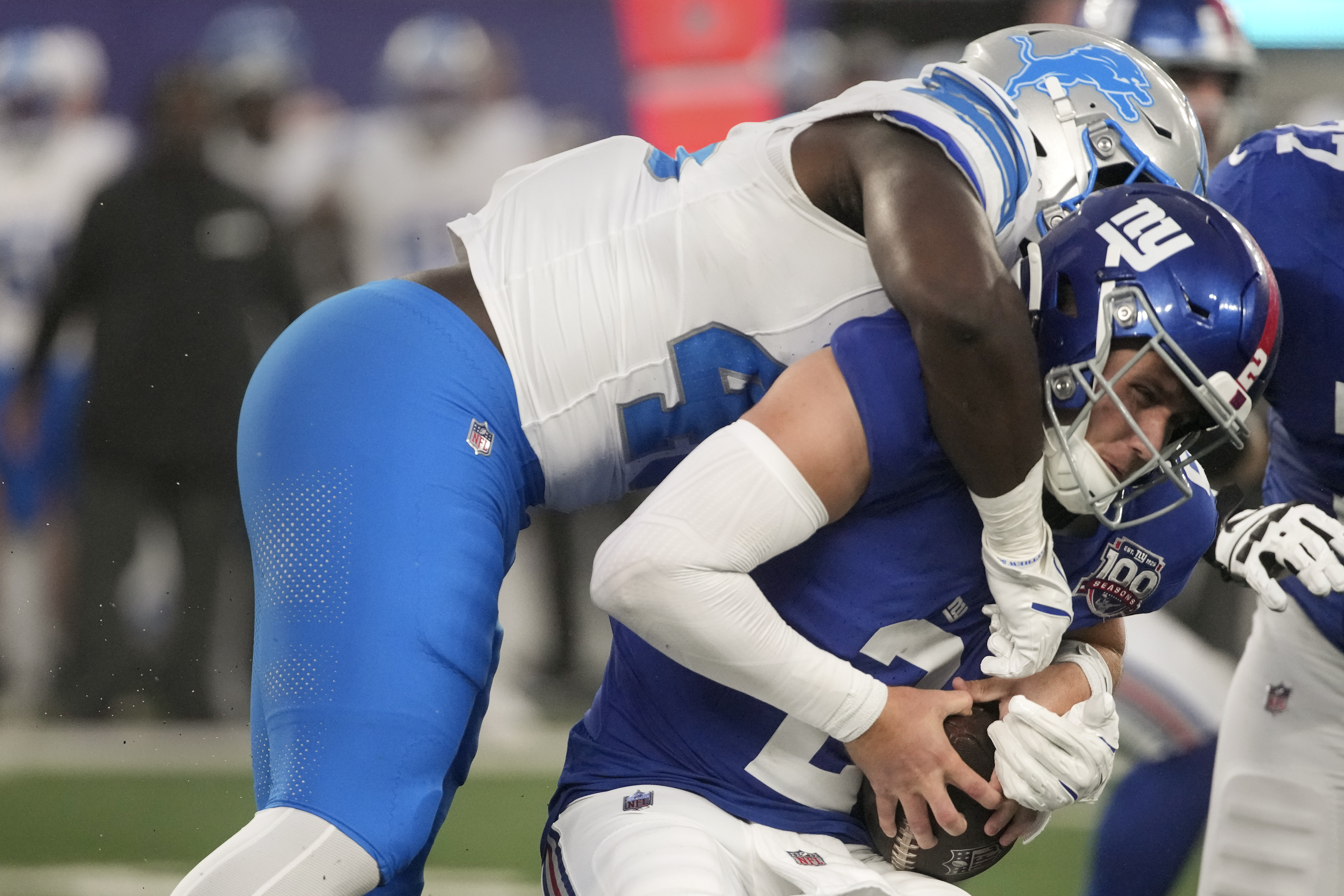 New York Giants quarterback Drew Lock (2) is sacked by Detroit Lions defensive end Isaac Ukwu (45) during the first quarter of an NFL football game, Thursday, Aug. 8, 2024, in East Rutherford, N.J. 